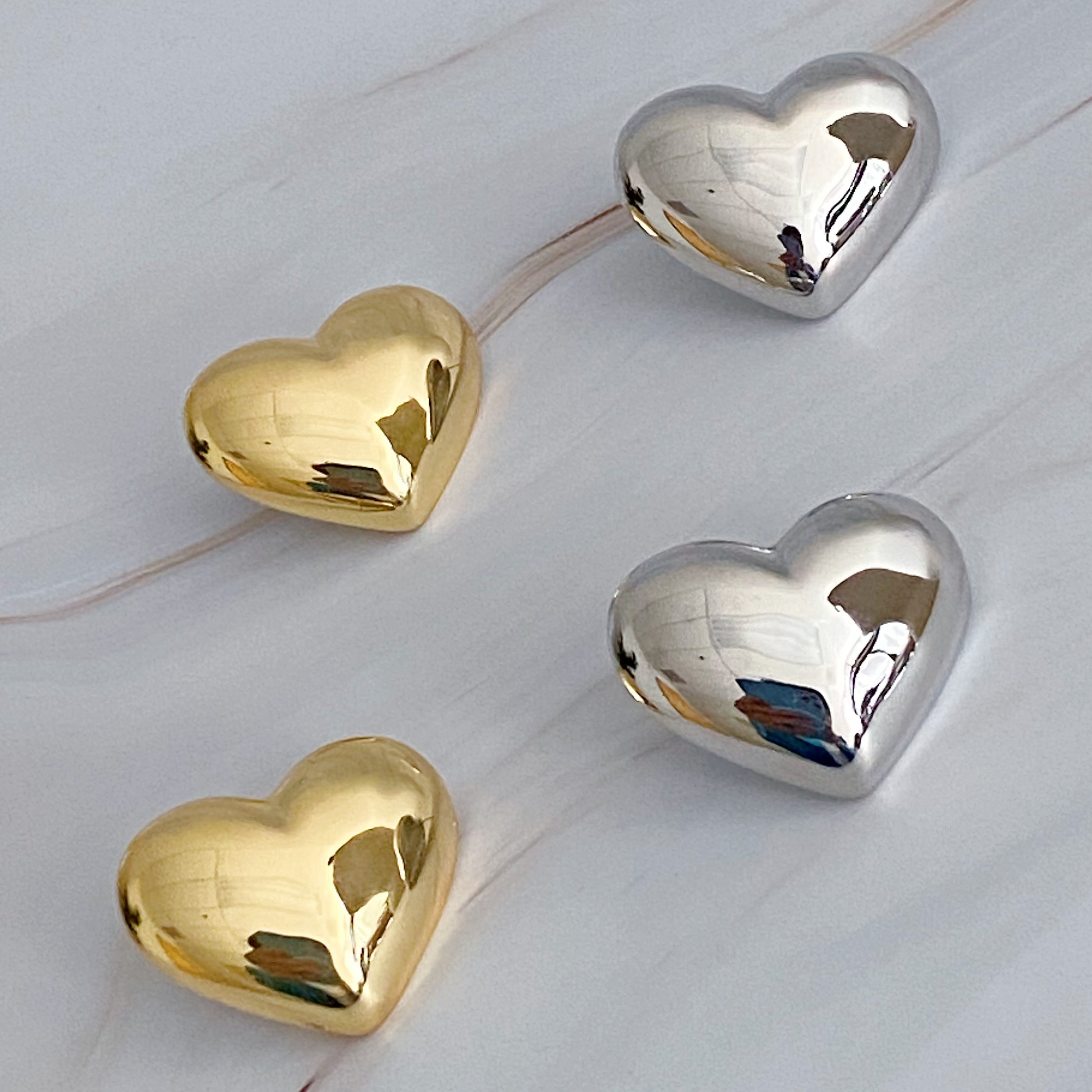 Polish My Heart Stud Earrings featuring a dimensional shape with a polished front and hallowed back, crafted in 18k gold or rhodium plated brass.