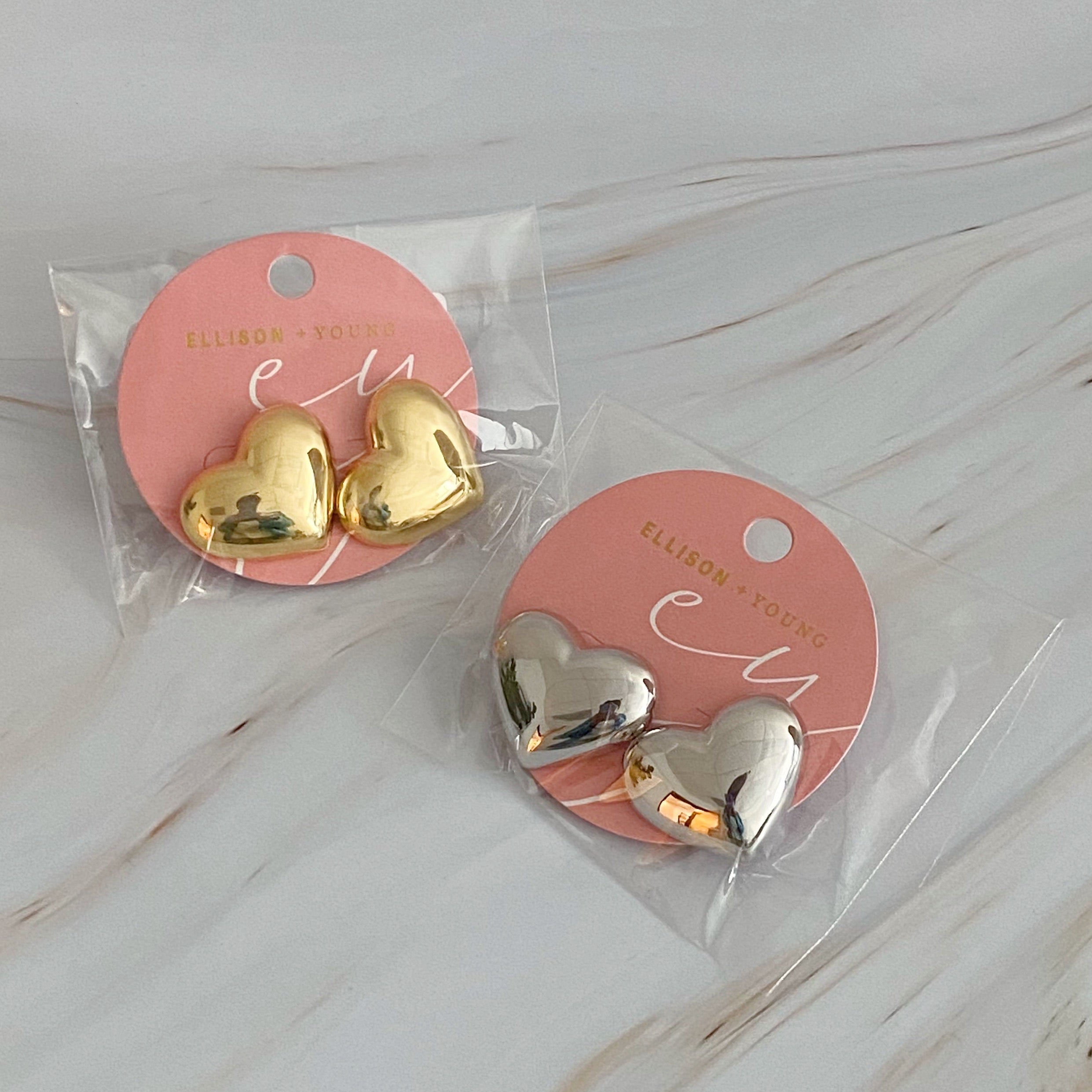 Polish My Heart Stud Earrings featuring a dimensional shape with a polished front and hallowed back, crafted in 18k gold or rhodium plated brass.