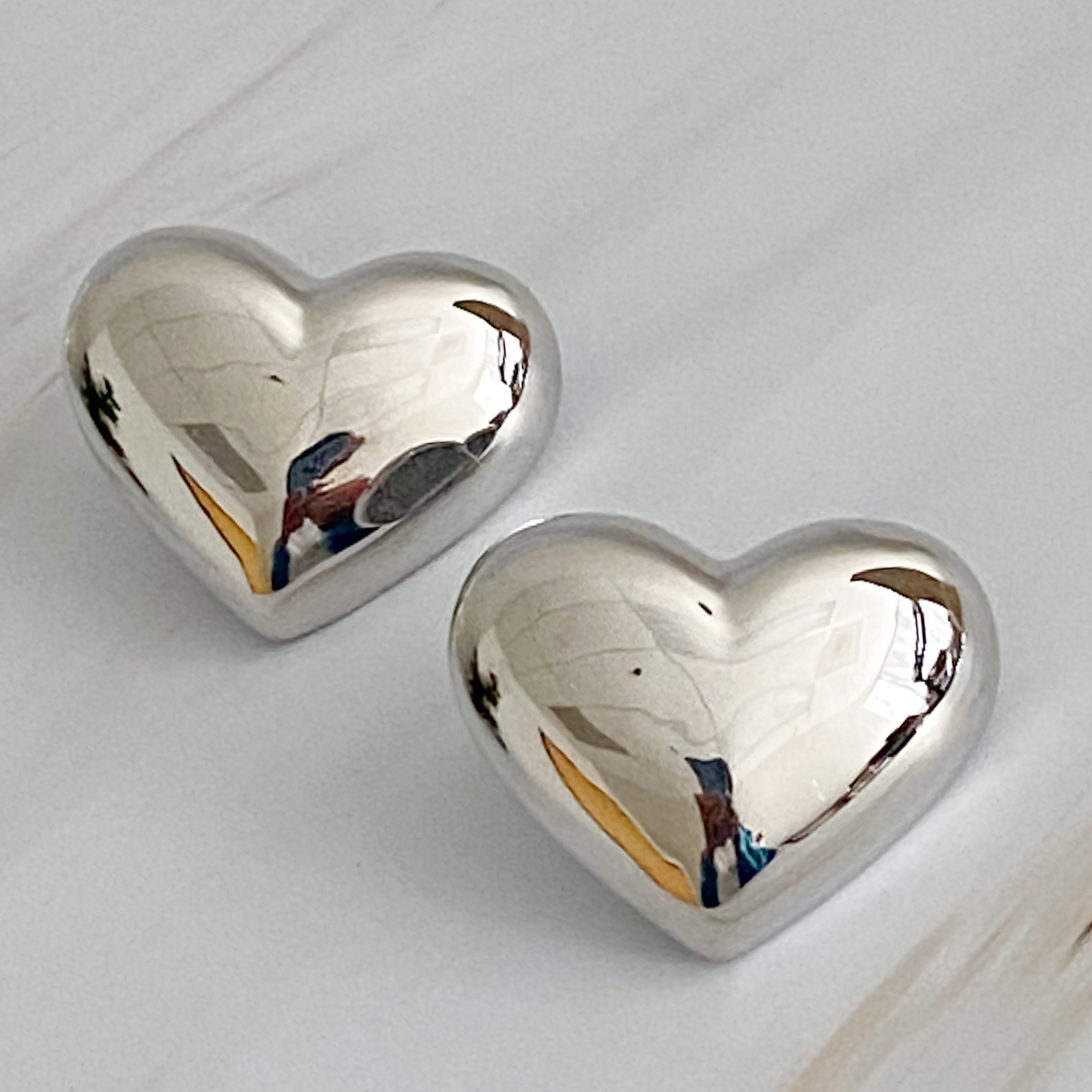 Polish My Heart Stud Earrings featuring a dimensional shape with a polished front and hallowed back, crafted in 18k gold or rhodium plated brass.