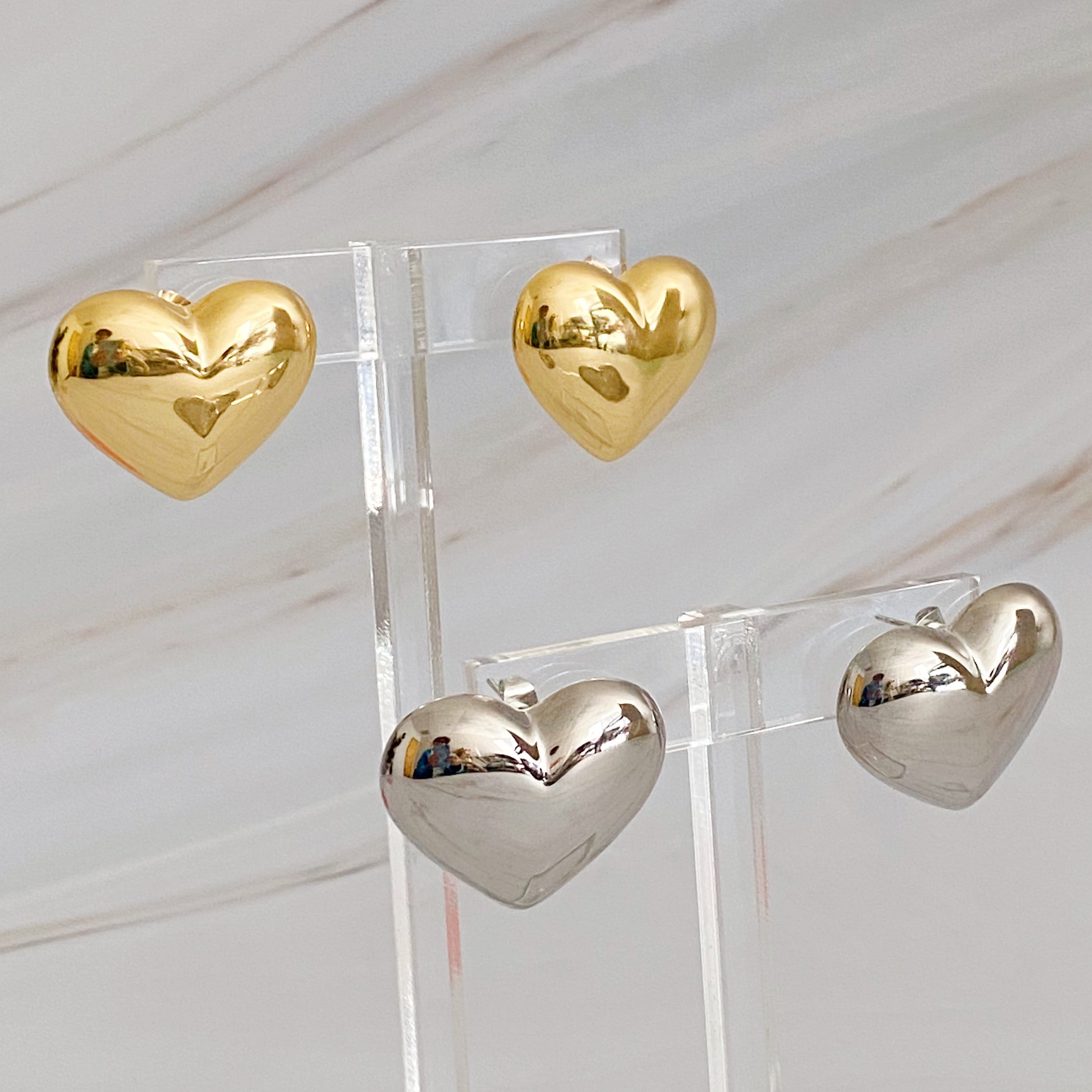 Polish My Heart Stud Earrings featuring a dimensional shape with a polished front and hallowed back, crafted in 18k gold or rhodium plated brass.