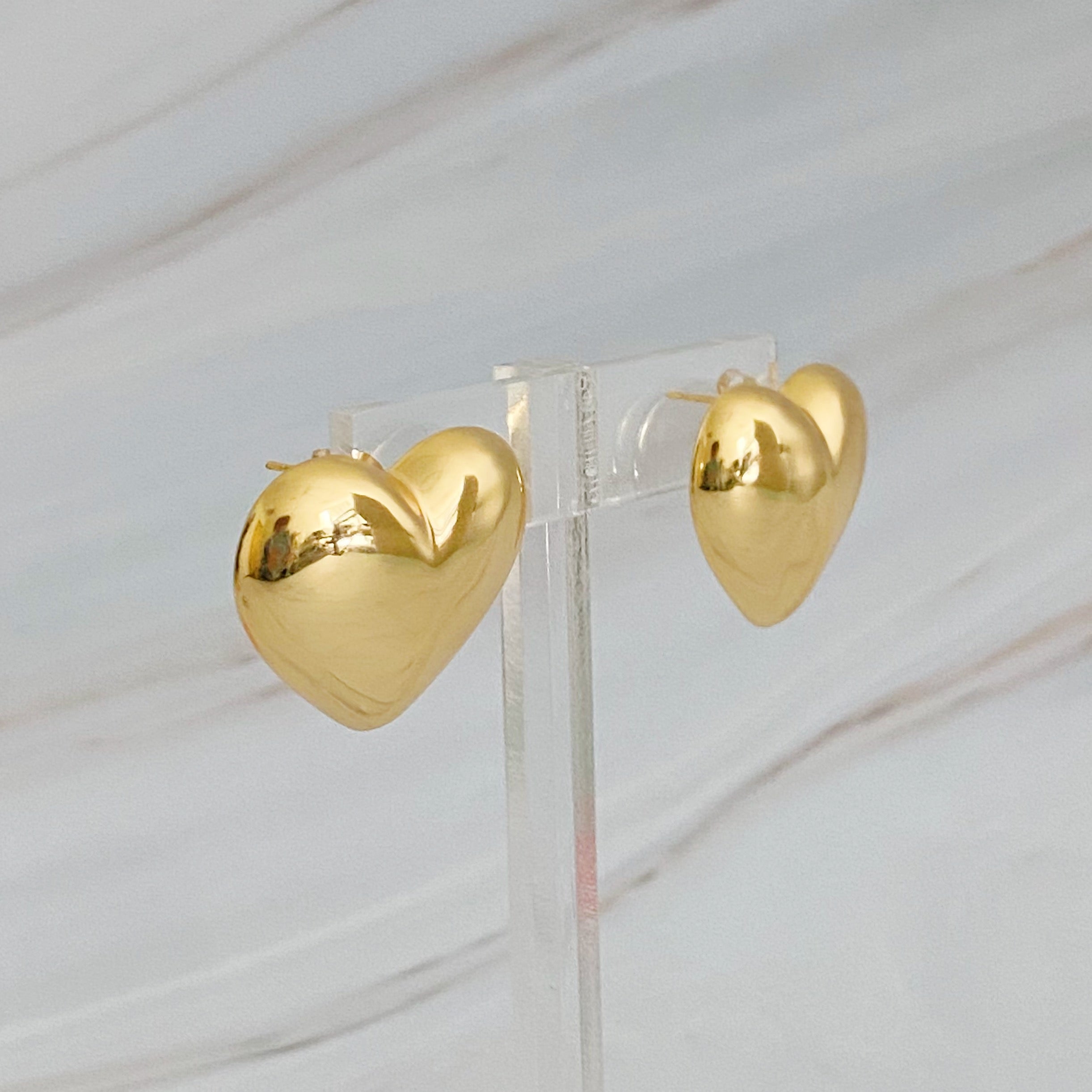 Polish My Heart Stud Earrings featuring a dimensional shape with a polished front and hallowed back, crafted in 18k gold or rhodium plated brass.