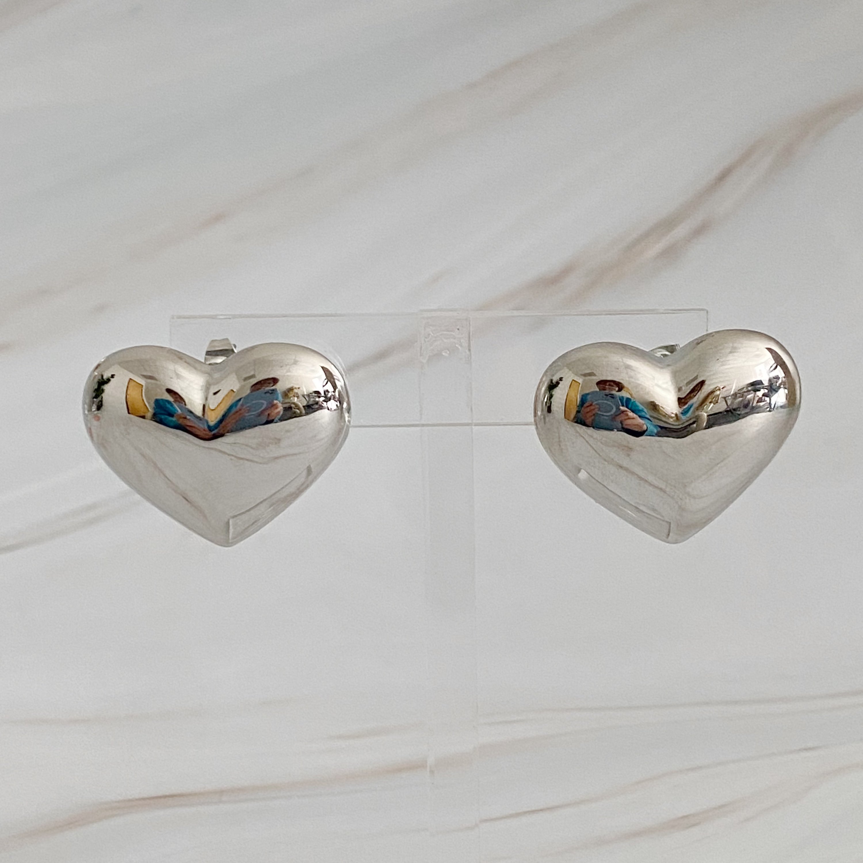 Polish My Heart Stud Earrings featuring a dimensional shape with a polished front and hallowed back, crafted in 18k gold or rhodium plated brass.