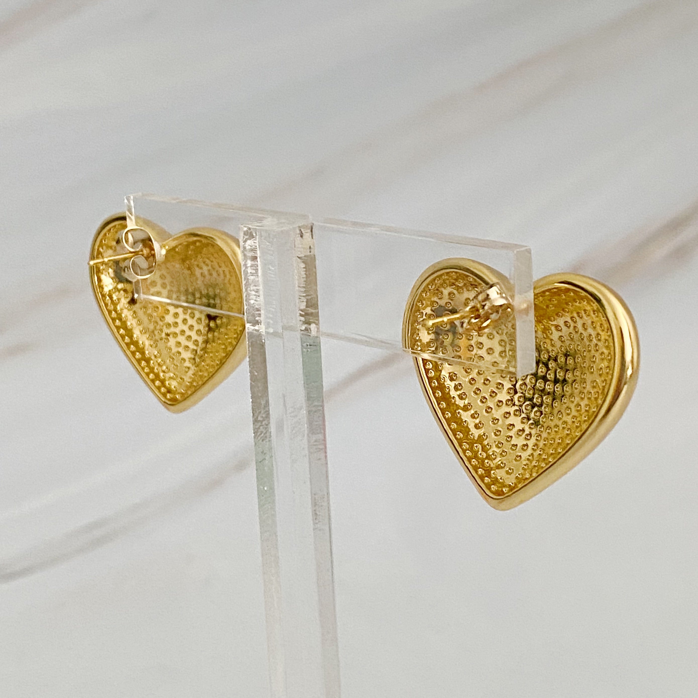 Polish My Heart Stud Earrings featuring a dimensional shape with a polished front and hallowed back, crafted in 18k gold or rhodium plated brass.