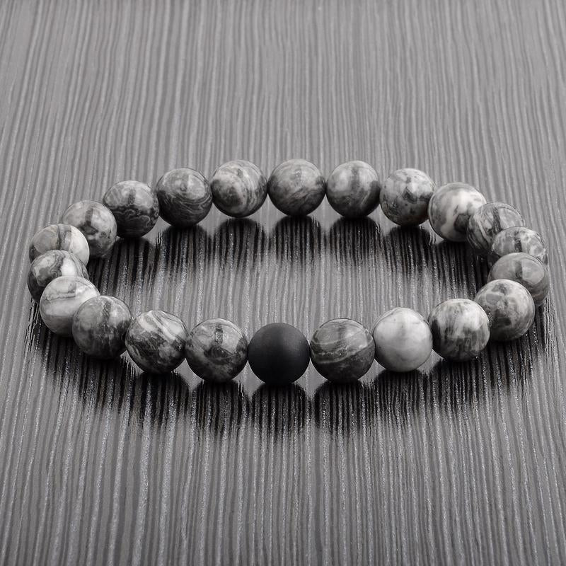 Polished 10mm Natural Stone Bead Stretch Bracelet made of Jasper with a matte black onyx bead, showcasing its elegant design.
