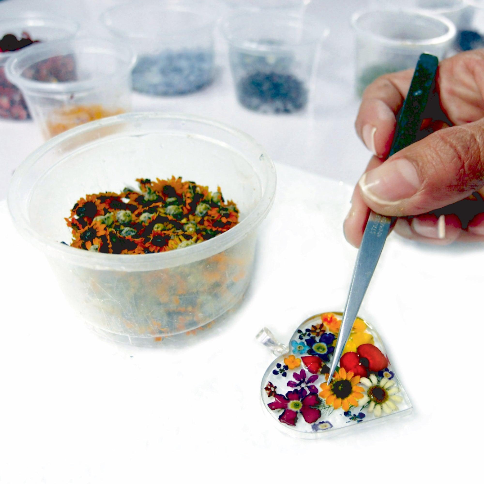 Poppy bracelet by Shrieking Violet featuring sterling silver beads and a real flower charm, elegantly displayed in a gift box.