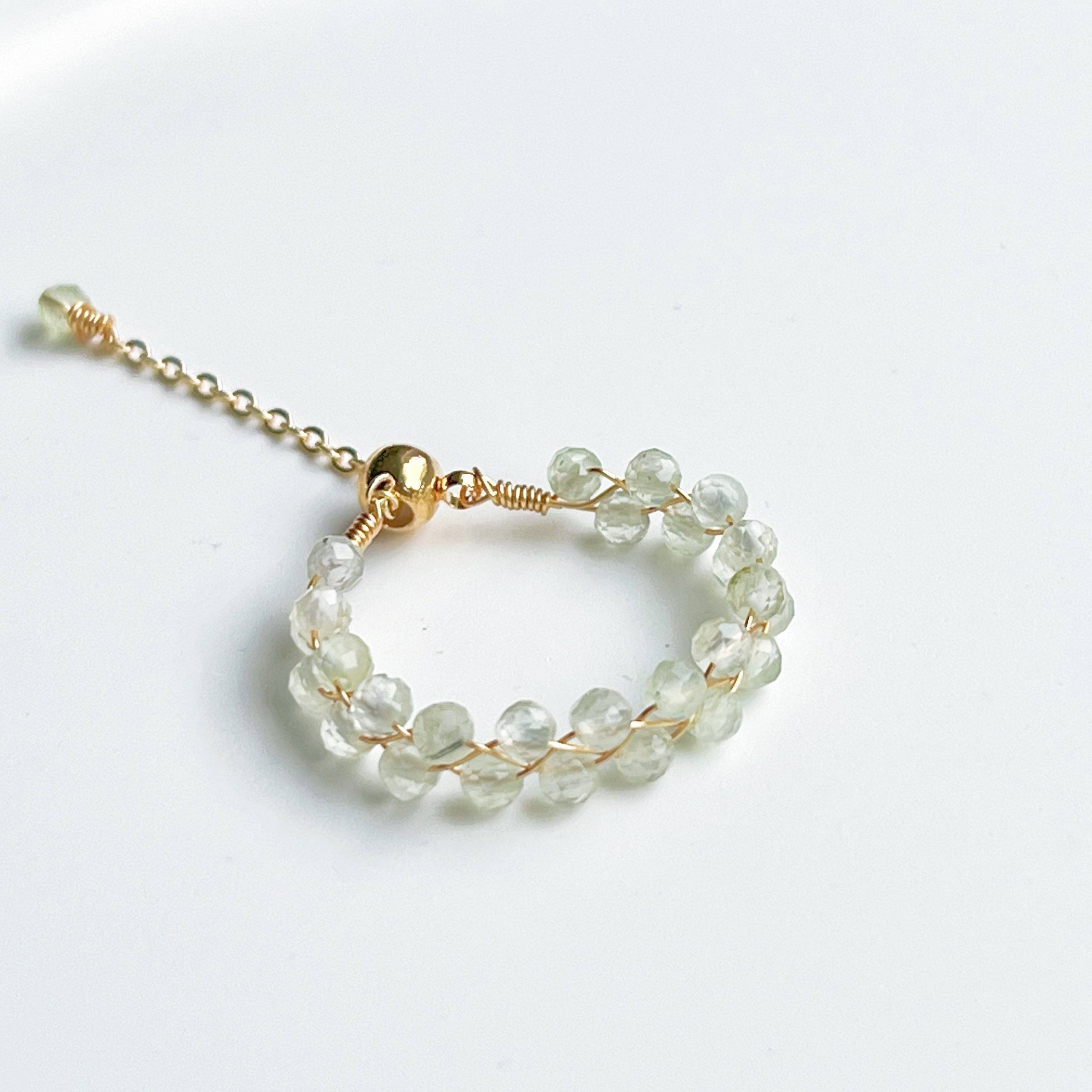 Light green Prehnite beaded adjustable ring with gold plated bronze wire, symbolizing love and healing.