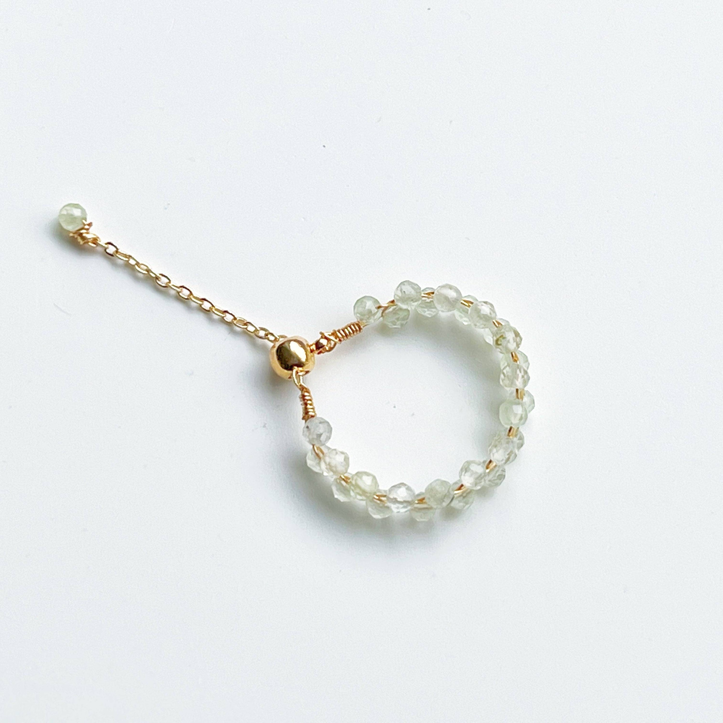 Light green Prehnite beaded adjustable ring with gold plated bronze wire, symbolizing love and healing.