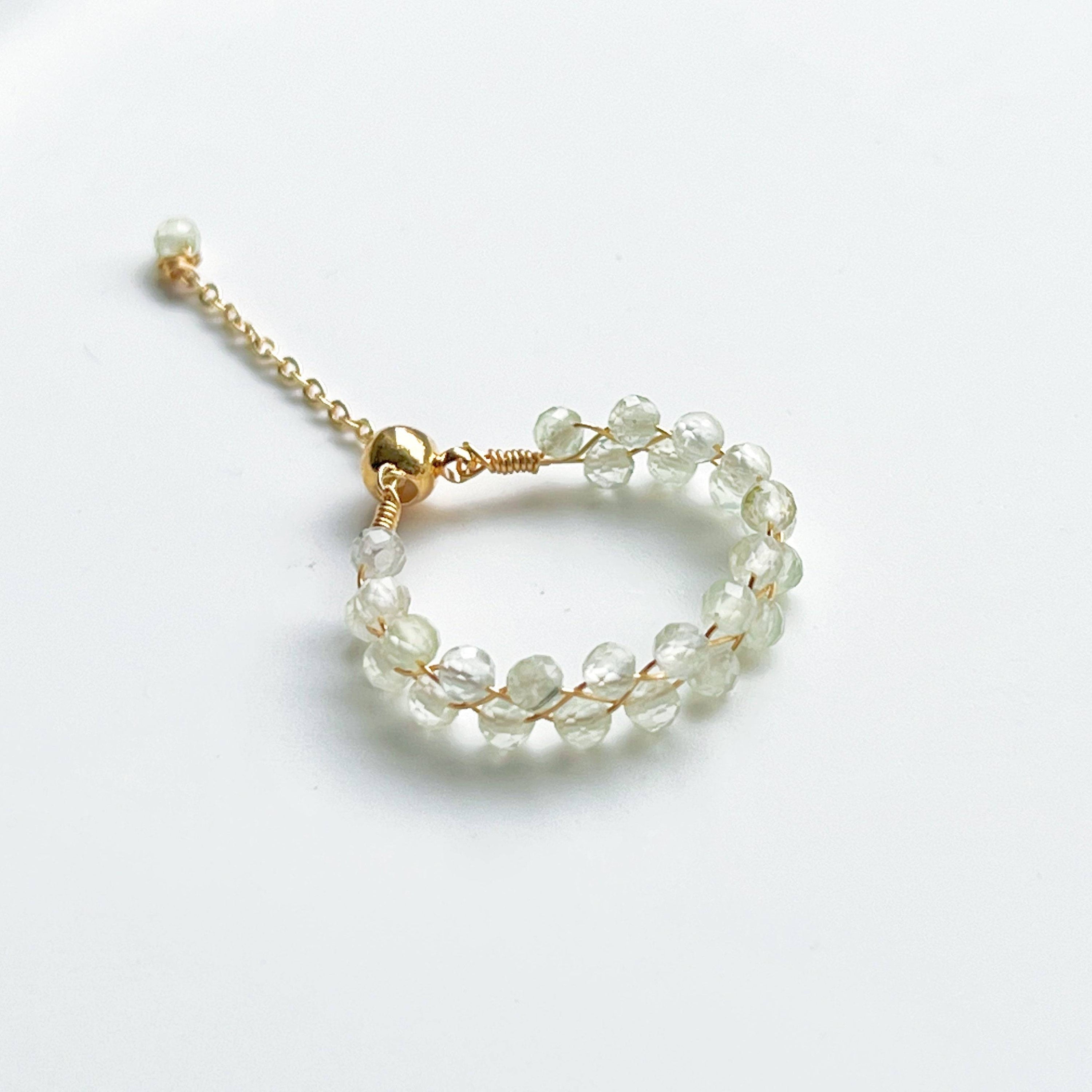 Light green Prehnite beaded adjustable ring with gold plated bronze wire, symbolizing love and healing.