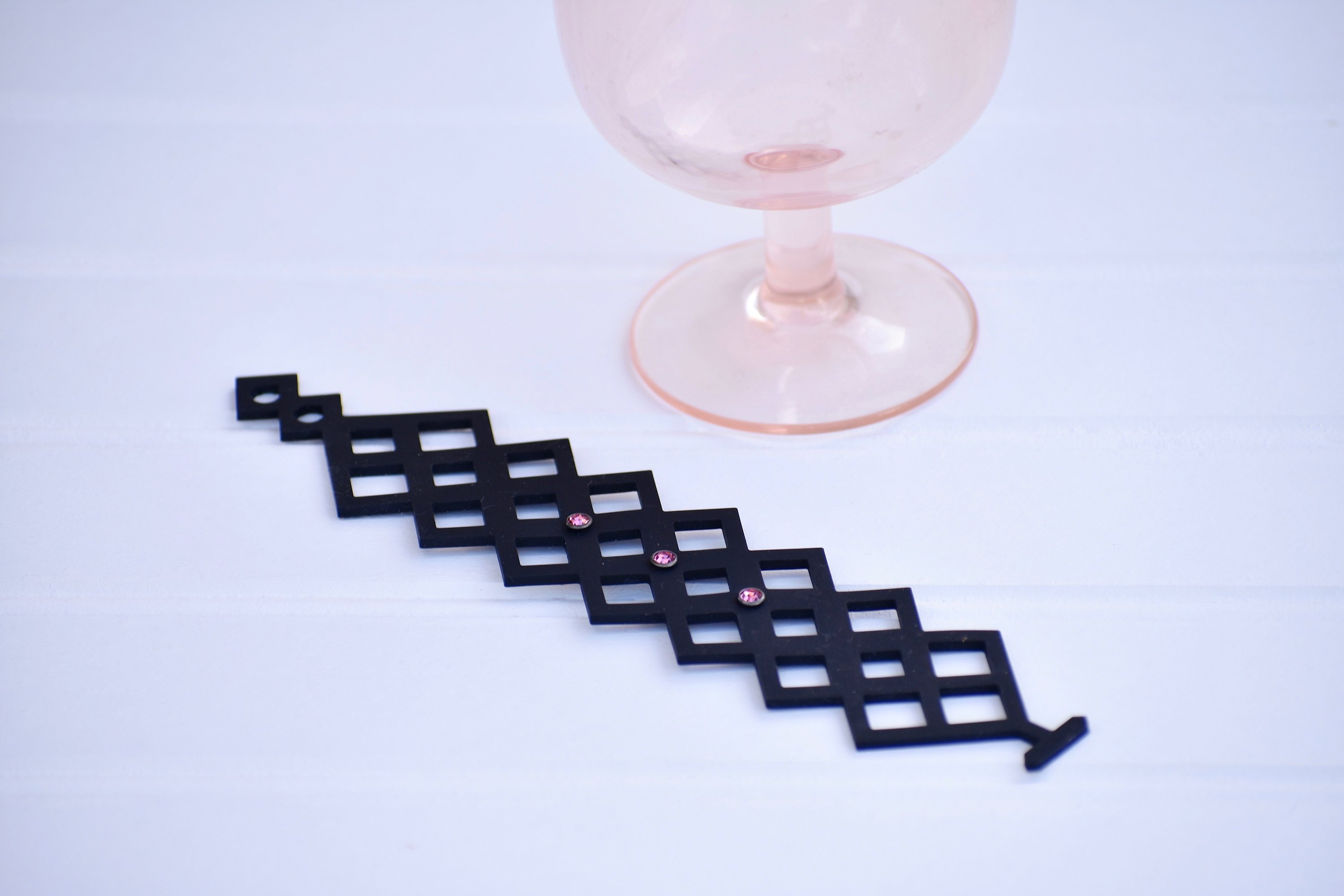 A stylish Pretty Bracelet displayed elegantly in a velvet pouch, showcasing its unique design and vibrant colors.