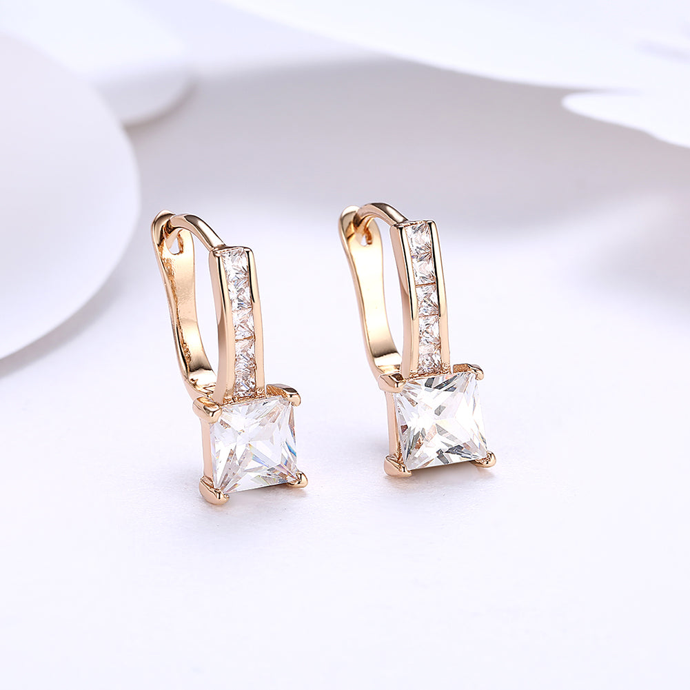 Elegant 18K gold plated princess cut square huggie earrings adorned with crystals, displayed in a white gift box.