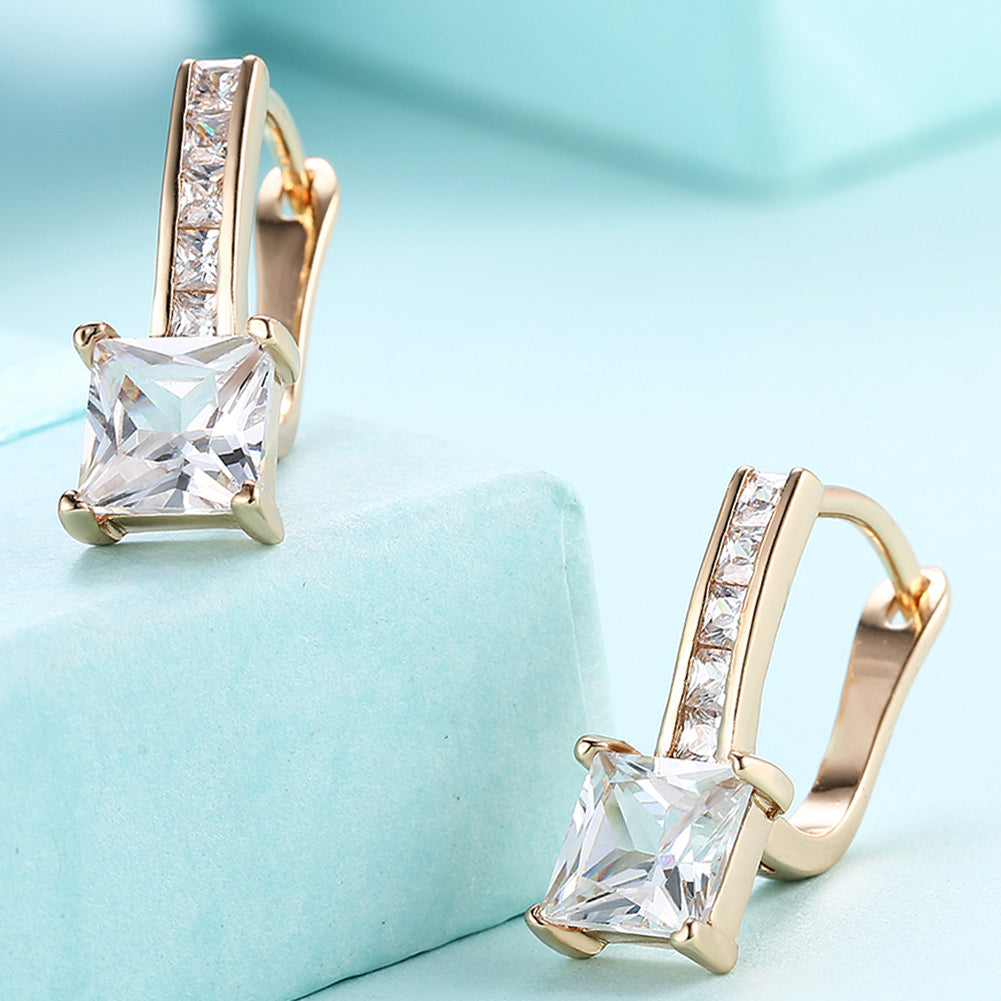 Elegant 18K gold plated princess cut square huggie earrings adorned with crystals, displayed in a white gift box.