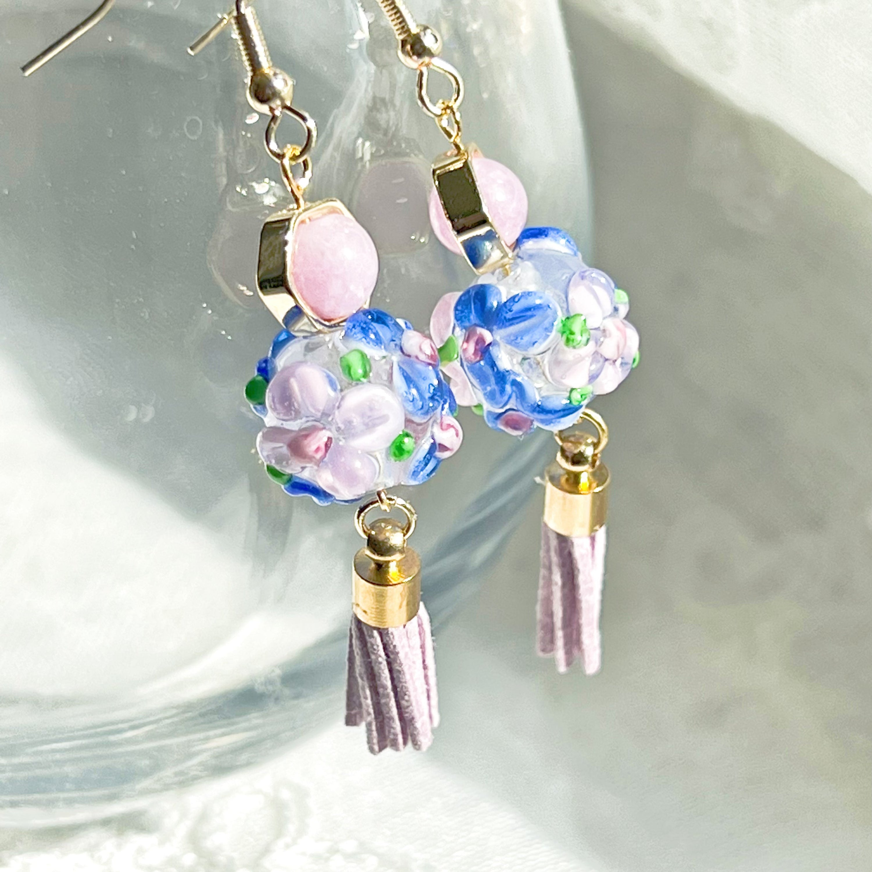 Purple hydrangea flower craft glass globe earrings with amethyst bead, showcasing intricate floral design and gold-plated sterling silver ear wire.