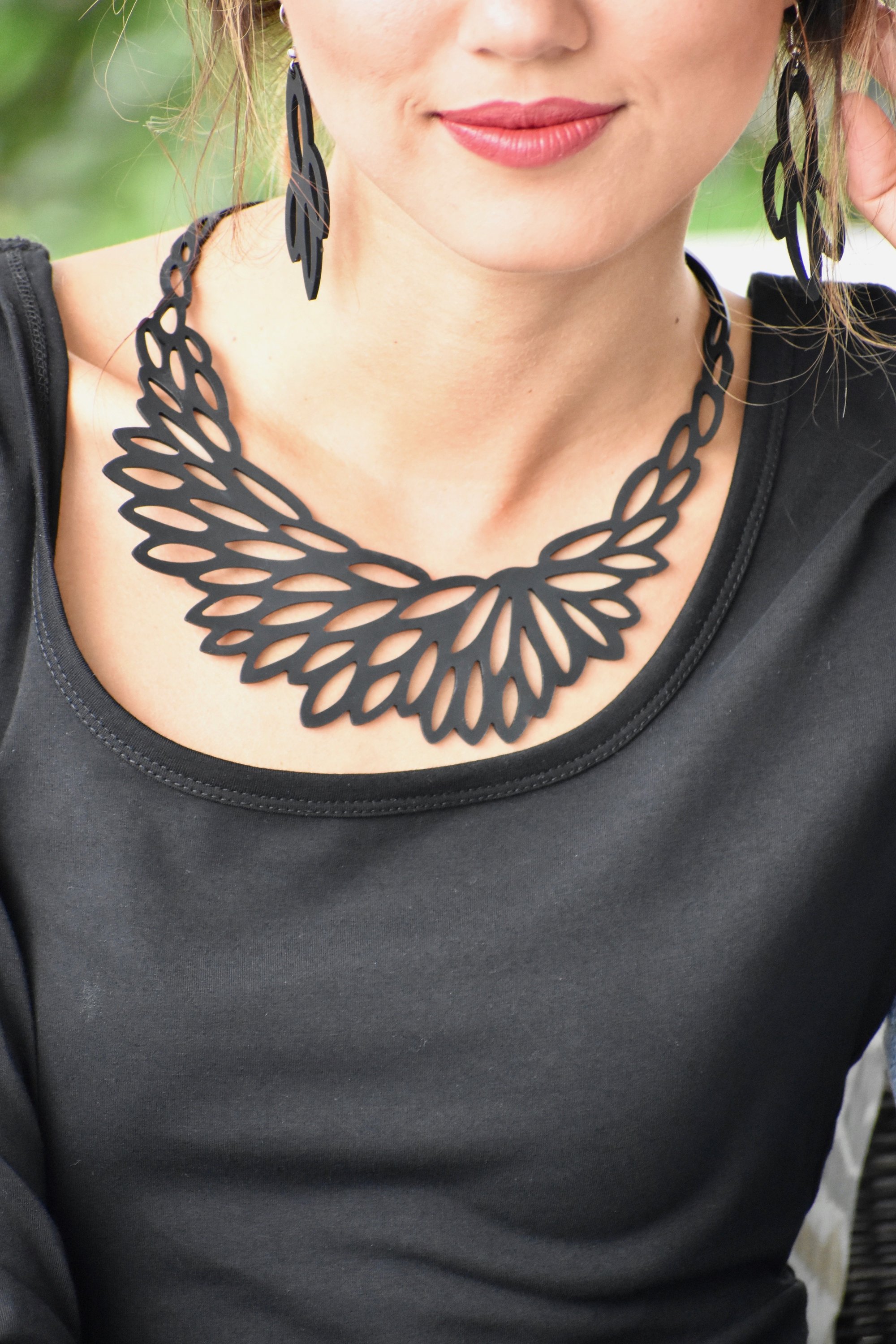 A stunning Radiant Necklace displayed elegantly in a velvet pouch, showcasing its unique design and lightweight features.