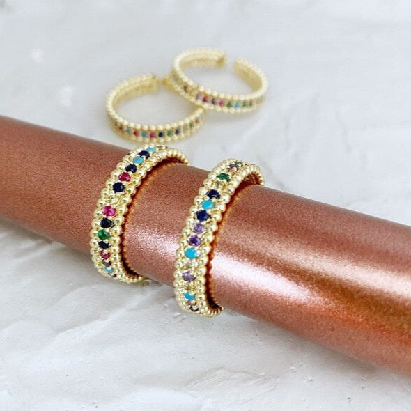 A beautiful adjustable Rainbow Gold Ring featuring multicolor CZ stones, showcasing a vibrant and elegant design.