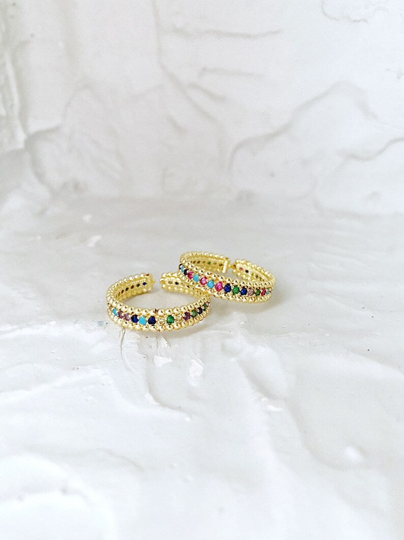 A beautiful adjustable Rainbow Gold Ring featuring multicolor CZ stones, showcasing a vibrant and elegant design.