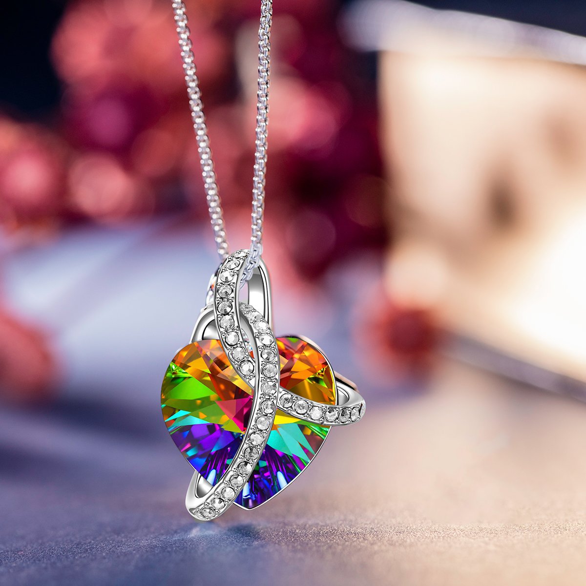 A stunning Rainbow Heart Crystal Necklace, elegantly designed with 18K gold plating, featuring a heart-shaped crystal and a secure lobster clasp.