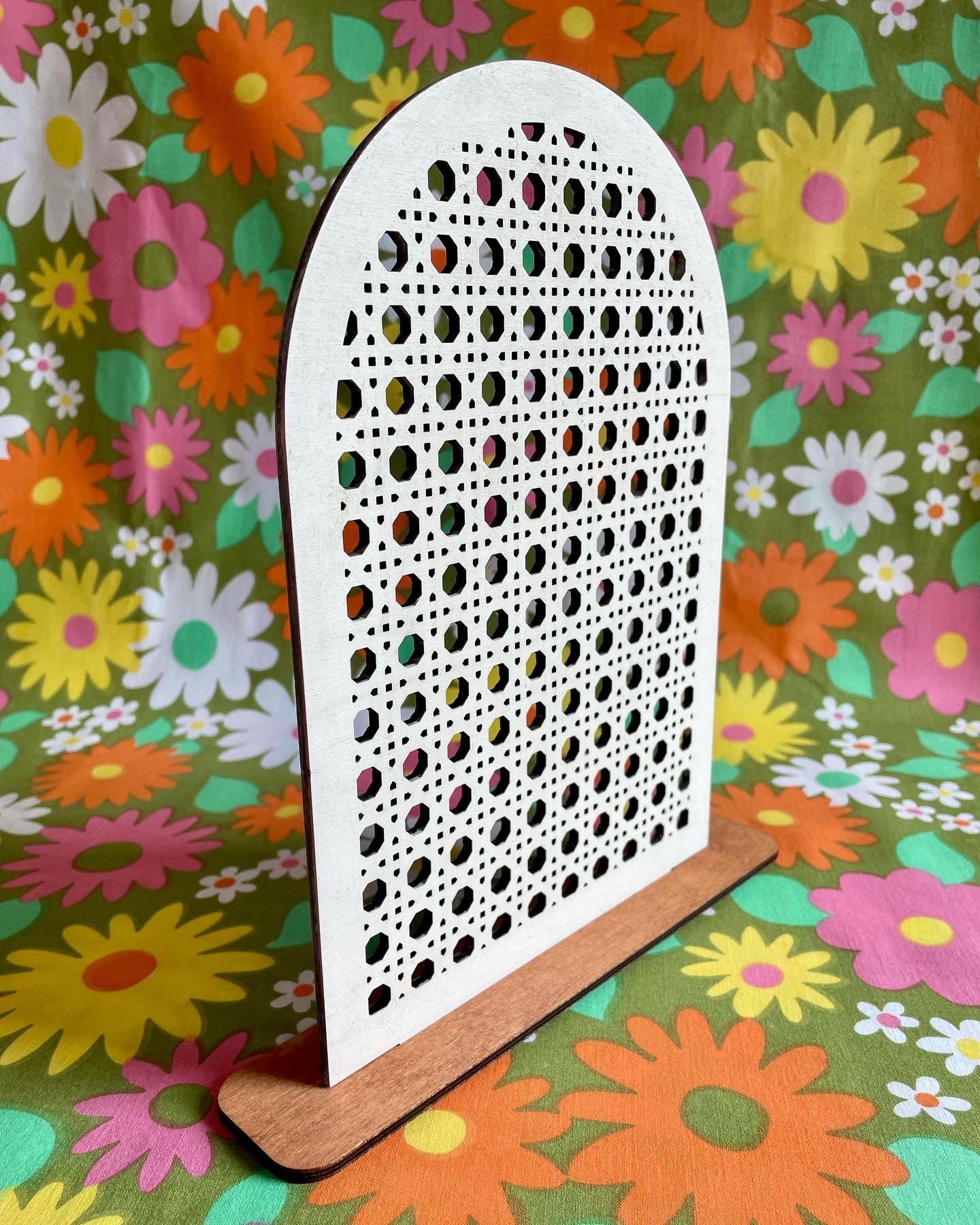 A stylish Rattan Earring Stand made from laser cut birch plywood, featuring a rattan effect design, perfect for organizing jewelry.