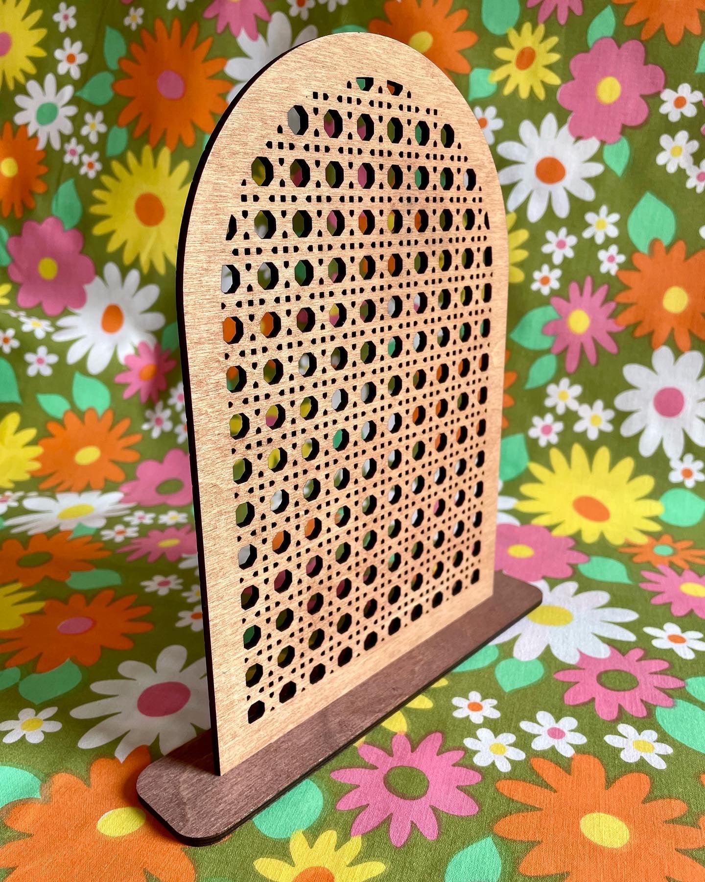 A stylish Rattan Earring Stand made from laser cut birch plywood, featuring a rattan effect design, perfect for organizing jewelry.