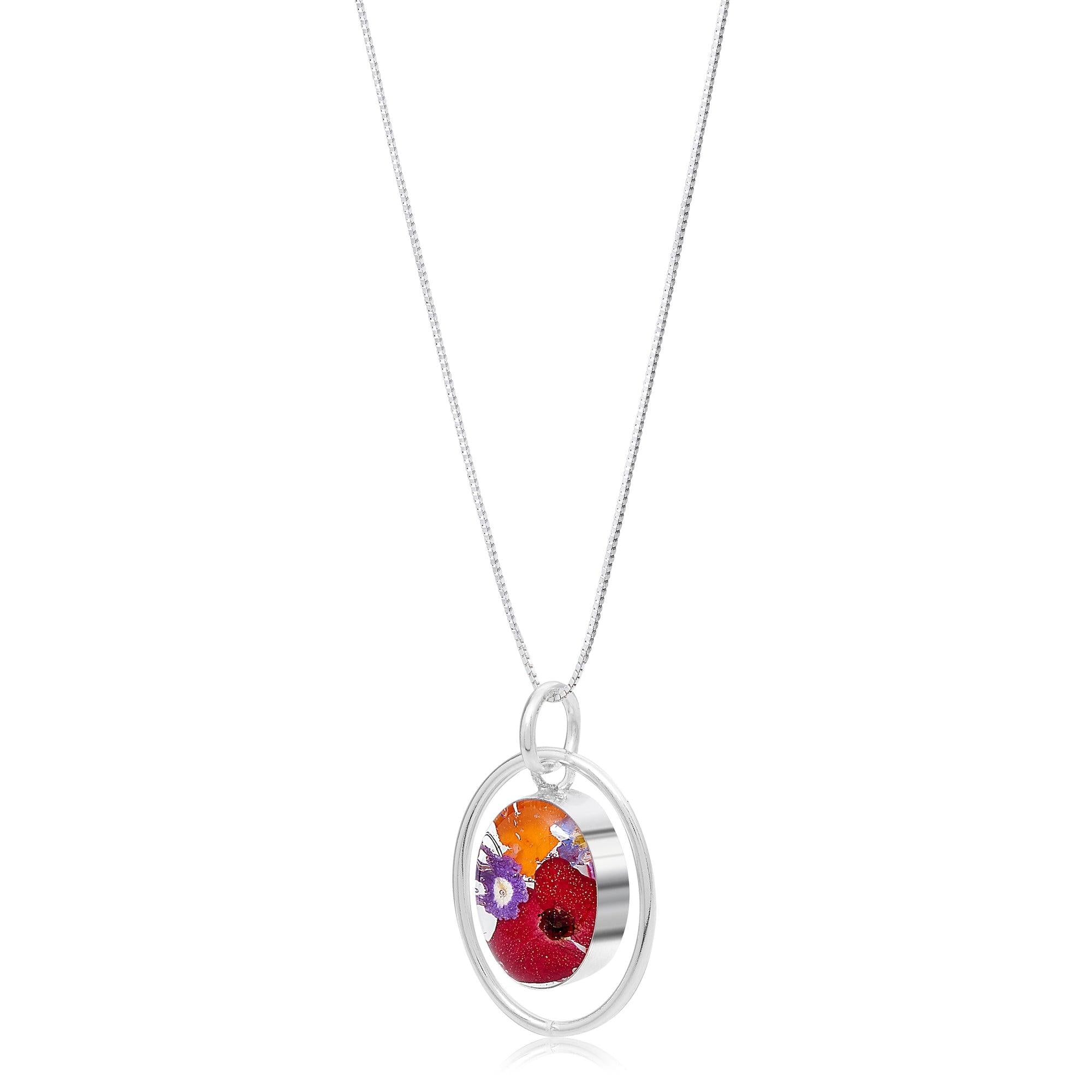 Real flower necklace featuring a sterling silver oval pendant with mixed flowers, handmade by Shrieking Violet.