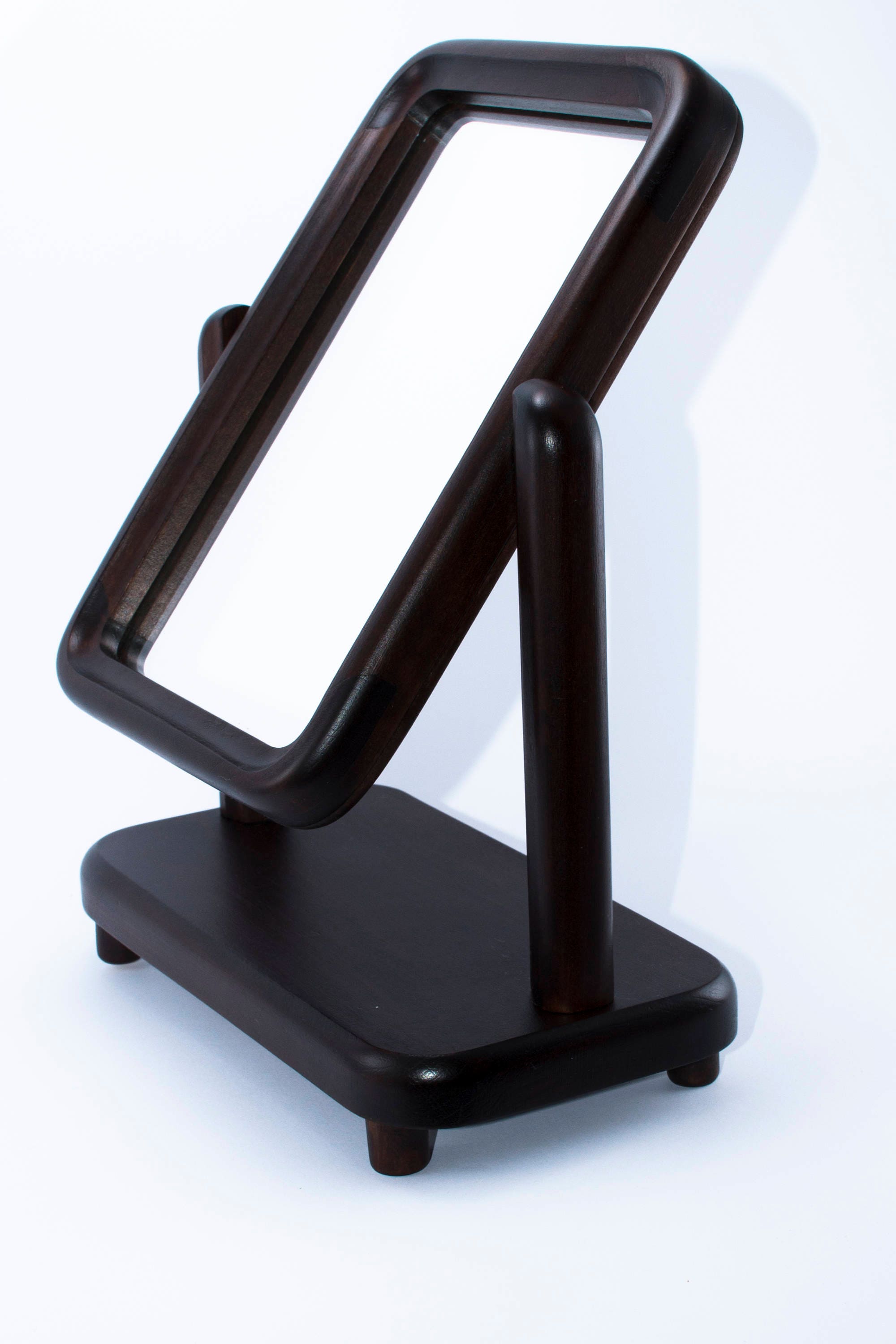 A beautifully crafted rectangular mirror with a wooden frame on a sturdy stand, showcasing its 360-degree rotation feature.