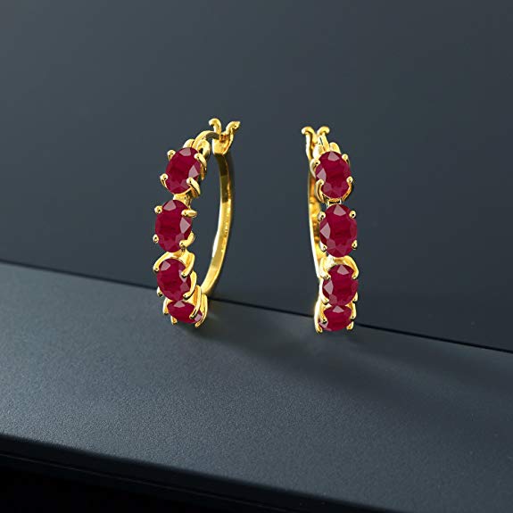 Elegant red crystal oval cut clip-on earrings with multi-stone lining in 14K gold plating, showcasing a luxurious design.