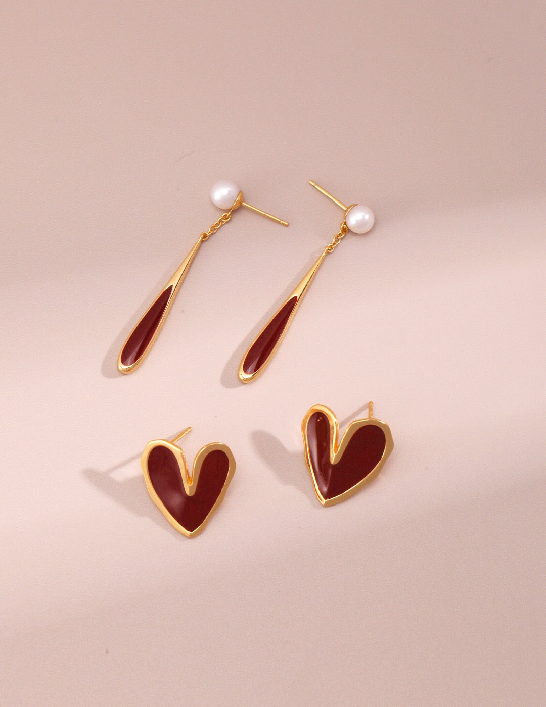 A pair of handmade Red Drip Glaze Folded Love Heart Earrings featuring a unique drip glaze finish and gold vermeil accents.