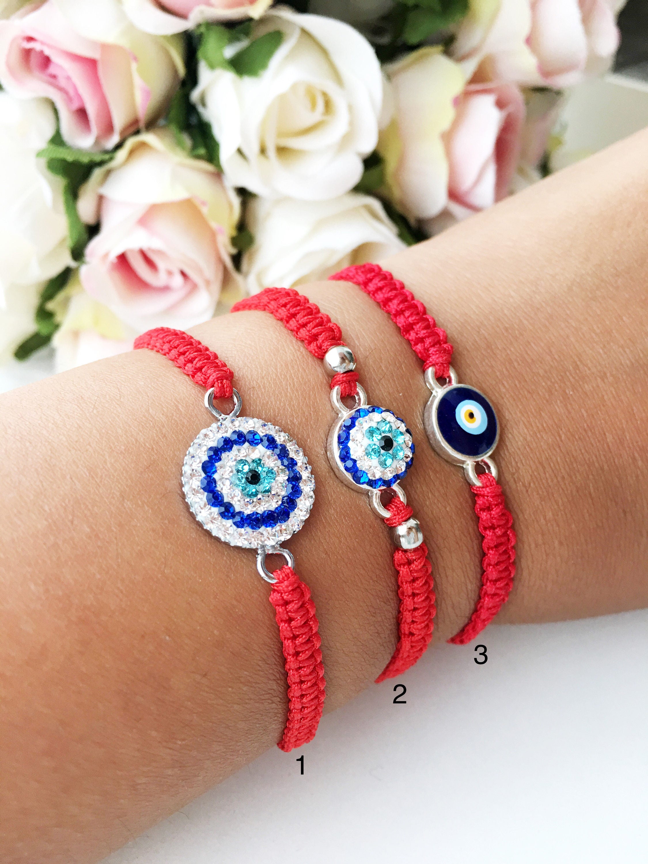 Handmade red evil eye bracelet with adjustable macrame design, featuring zircon and cotton materials.
