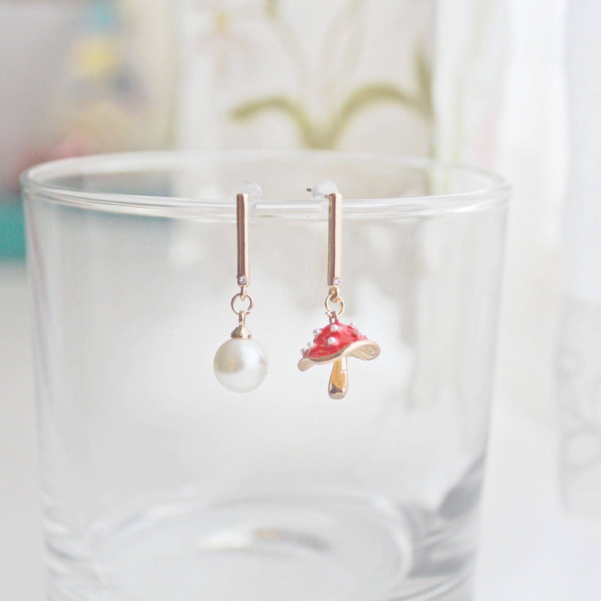 Drop earrings on a glass.