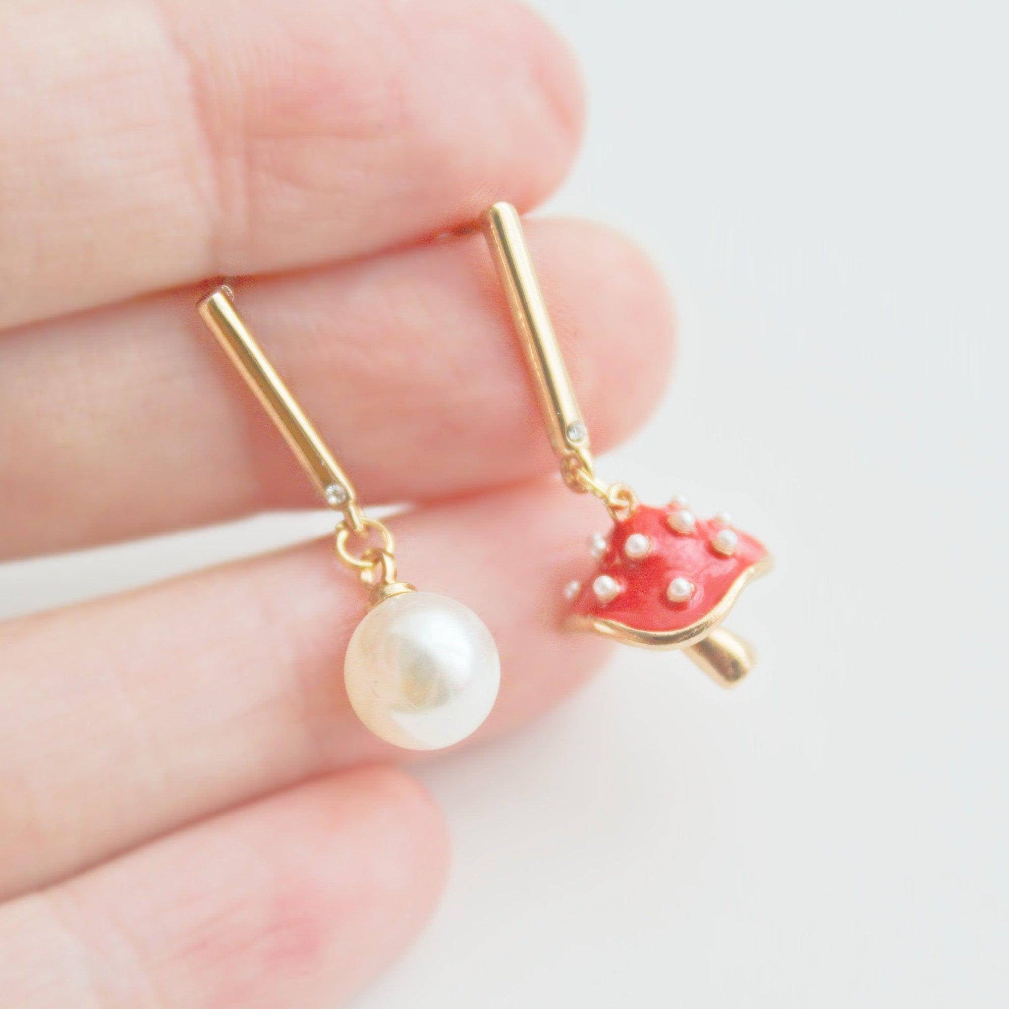 Gold earrings with pearl and mushroom.