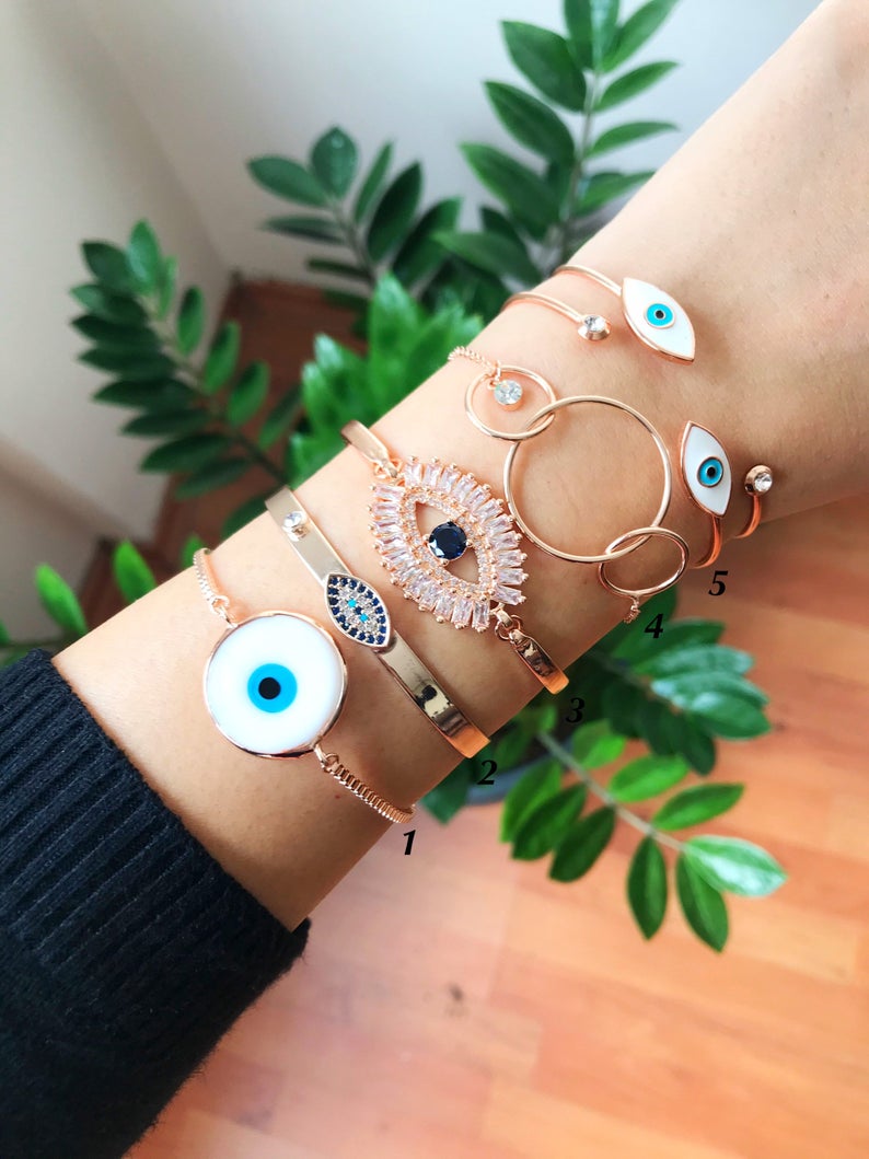 Rose Gold Evil Eye Bracelet Set featuring a movable oval charm and adjustable bangle design, crafted from tarnish-resistant stainless steel.