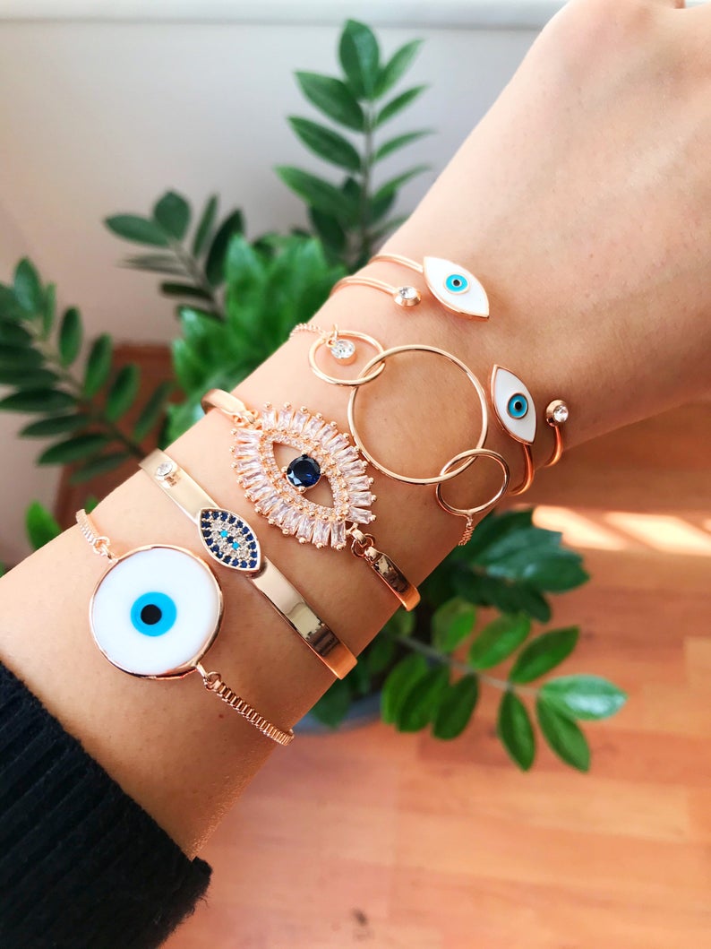 Rose Gold Evil Eye Bracelet Set featuring a movable oval charm and adjustable bangle design, crafted from tarnish-resistant stainless steel.