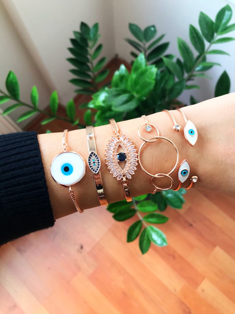 Rose Gold Evil Eye Bracelet Set featuring a movable oval charm and adjustable bangle design, crafted from tarnish-resistant stainless steel.