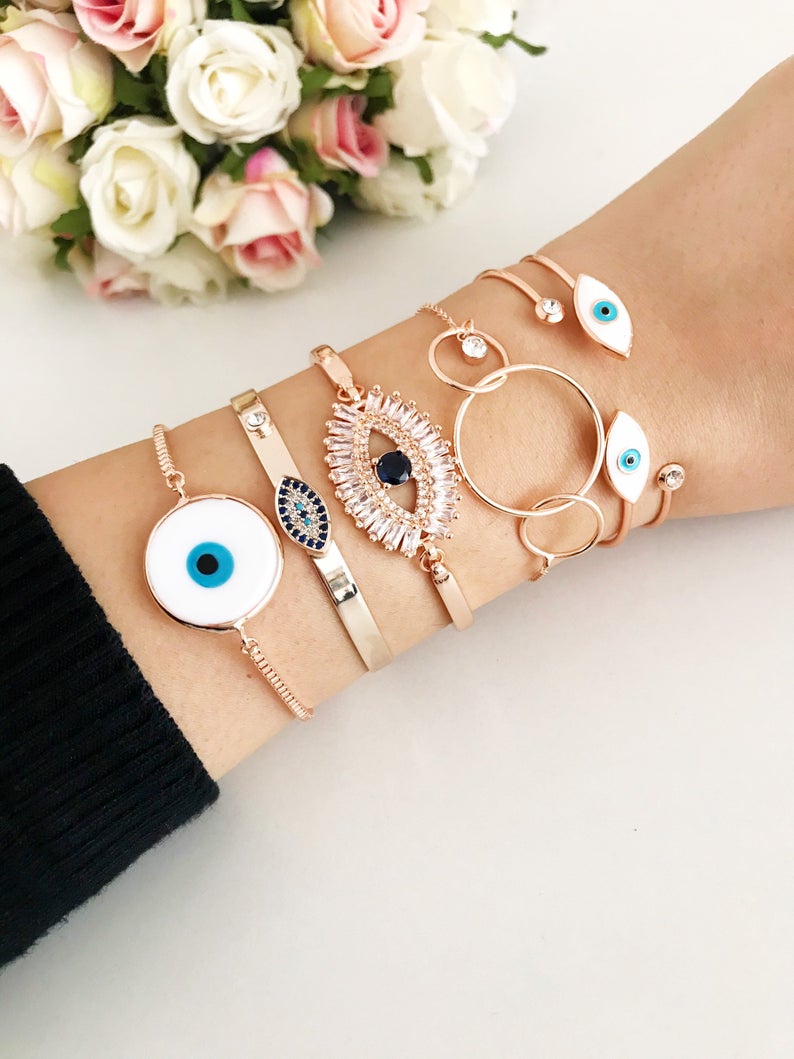 Rose Gold Evil Eye Bracelet Set featuring a movable oval charm and adjustable bangle design, crafted from tarnish-resistant stainless steel.