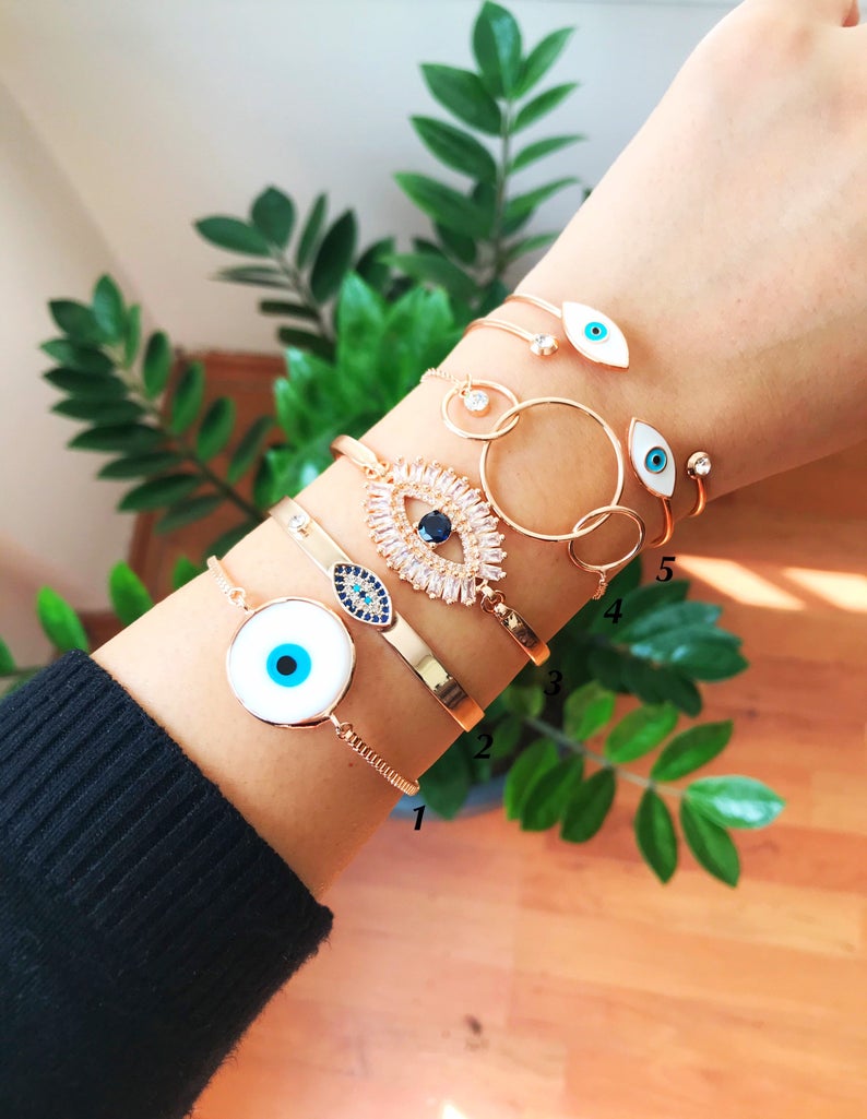 Rose Gold Evil Eye Bracelet Set featuring a movable oval charm and adjustable bangle design, crafted from tarnish-resistant stainless steel.