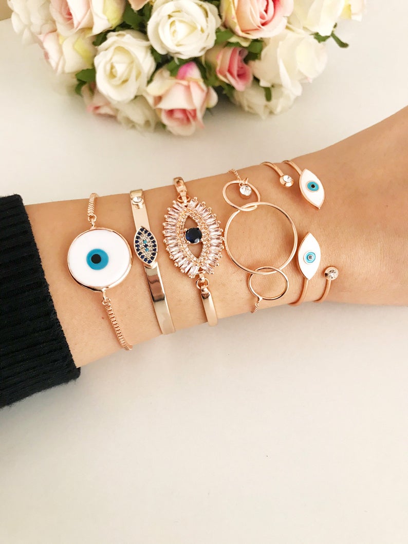 Rose Gold Evil Eye Bracelet Set featuring a movable oval charm and adjustable bangle design, crafted from tarnish-resistant stainless steel.