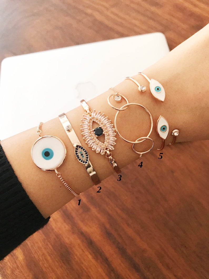 Rose Gold Evil Eye Bracelet Set featuring a movable oval charm and adjustable bangle design, crafted from tarnish-resistant stainless steel.