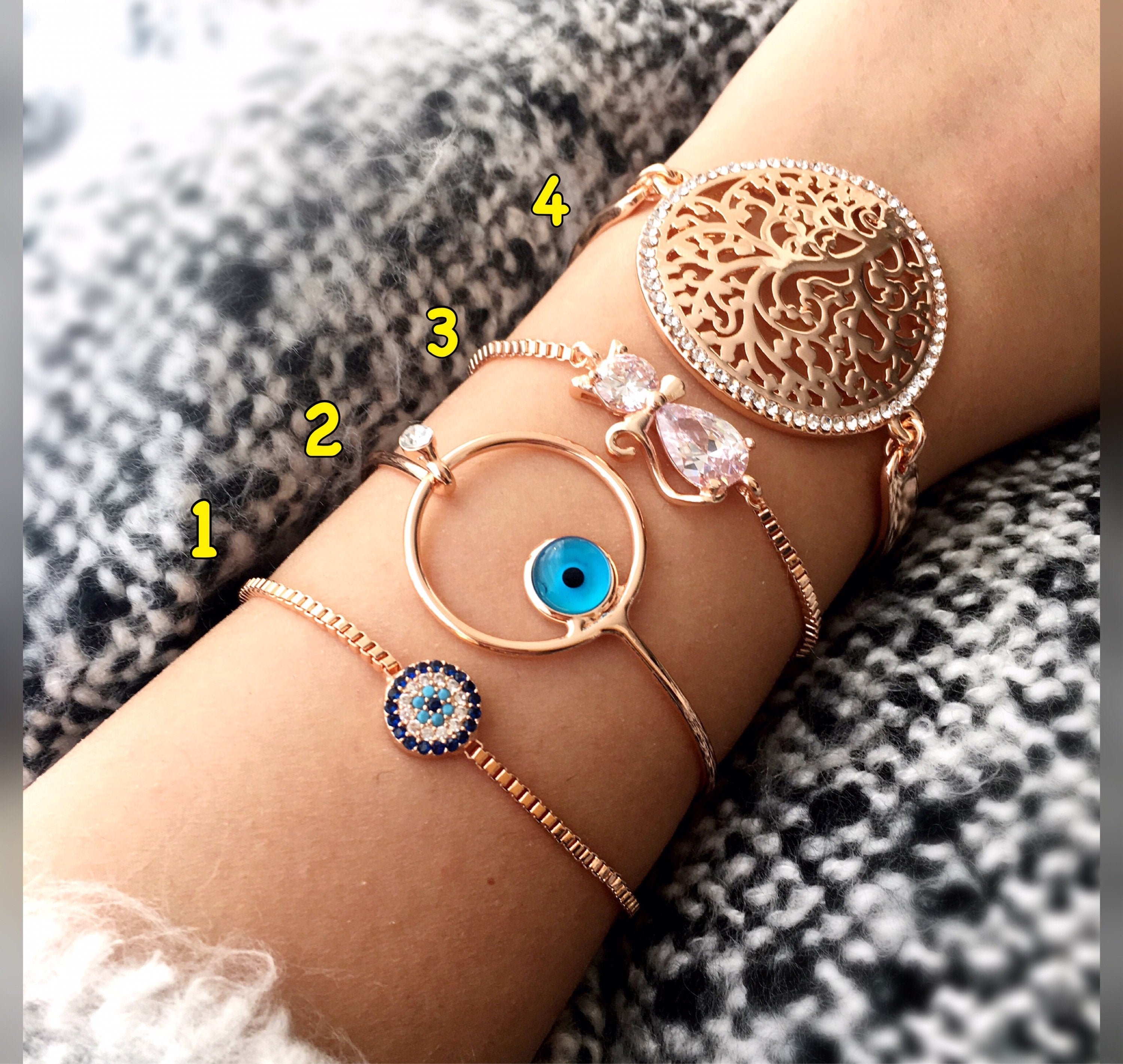 A beautiful rose gold evil eye bracelet featuring a tree of life charm, made from tarnish-resistant stainless steel and adorned with zirconia.