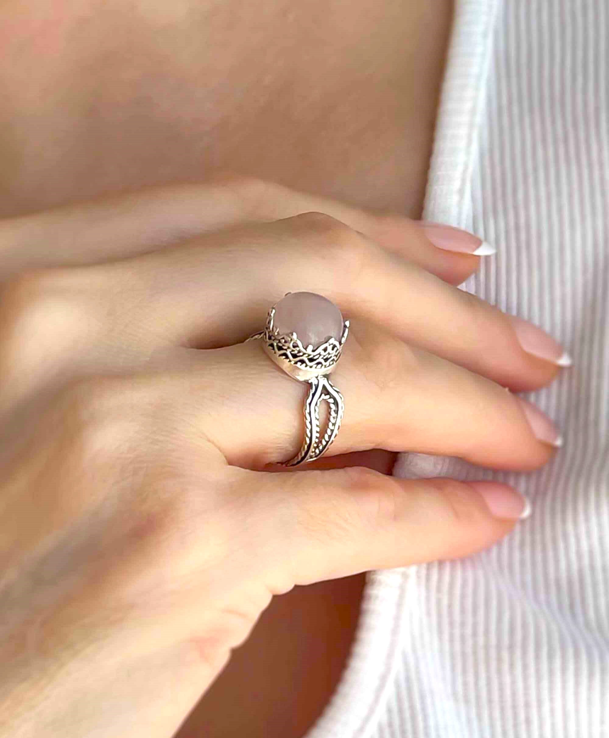 Elegant Rose Quartz Gemstone Filigree Art Sterling Silver Cocktail Ring featuring a round cut pink stone and intricate metalwork design.