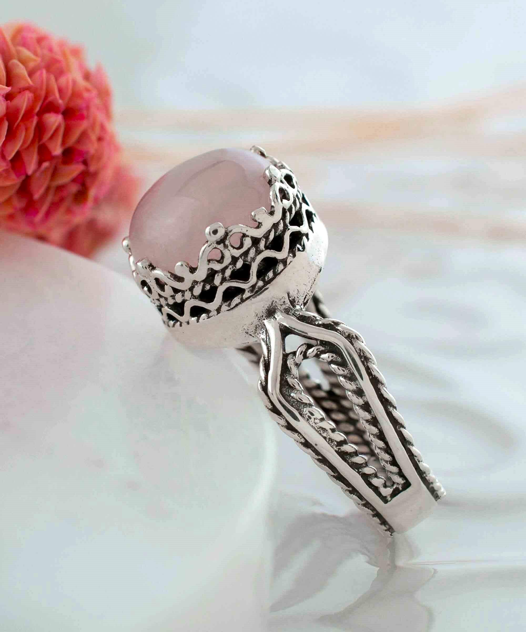 Elegant Rose Quartz Gemstone Filigree Art Sterling Silver Cocktail Ring featuring a round cut pink stone and intricate metalwork design.