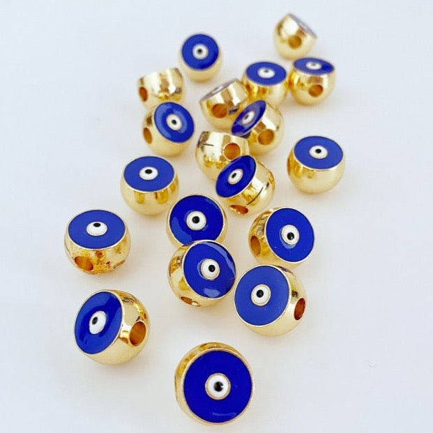 Round Blue Evil Eye Bead made of brass, featuring a vibrant blue color and intricate evil eye design, perfect for jewelry making.