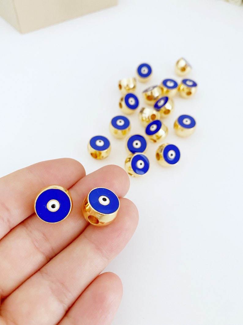 Round Blue Evil Eye Bead made of brass, featuring a vibrant blue color and intricate evil eye design, perfect for jewelry making.