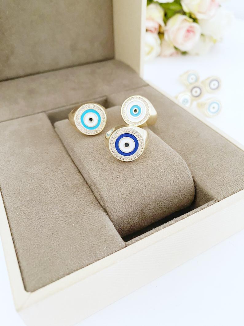 Adjustable gold Round Evil Eye Ring featuring a blue evil eye design, perfect for boho jewelry enthusiasts.
