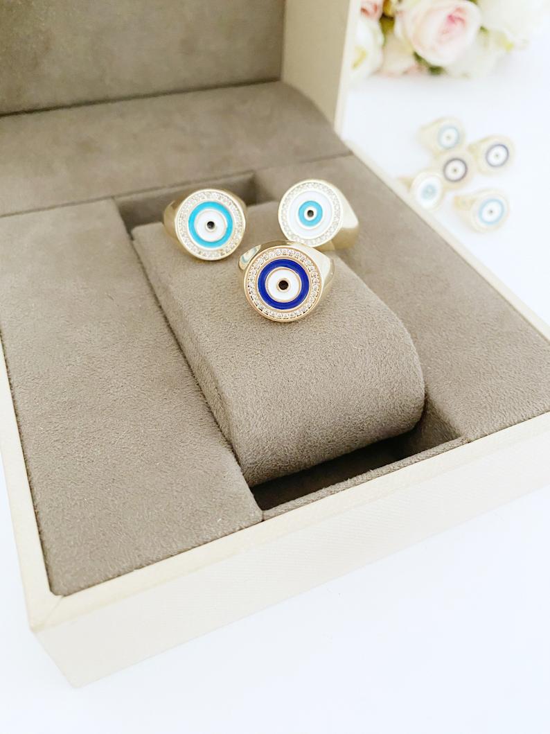 Adjustable gold Round Evil Eye Ring featuring a blue evil eye design, perfect for boho jewelry enthusiasts.