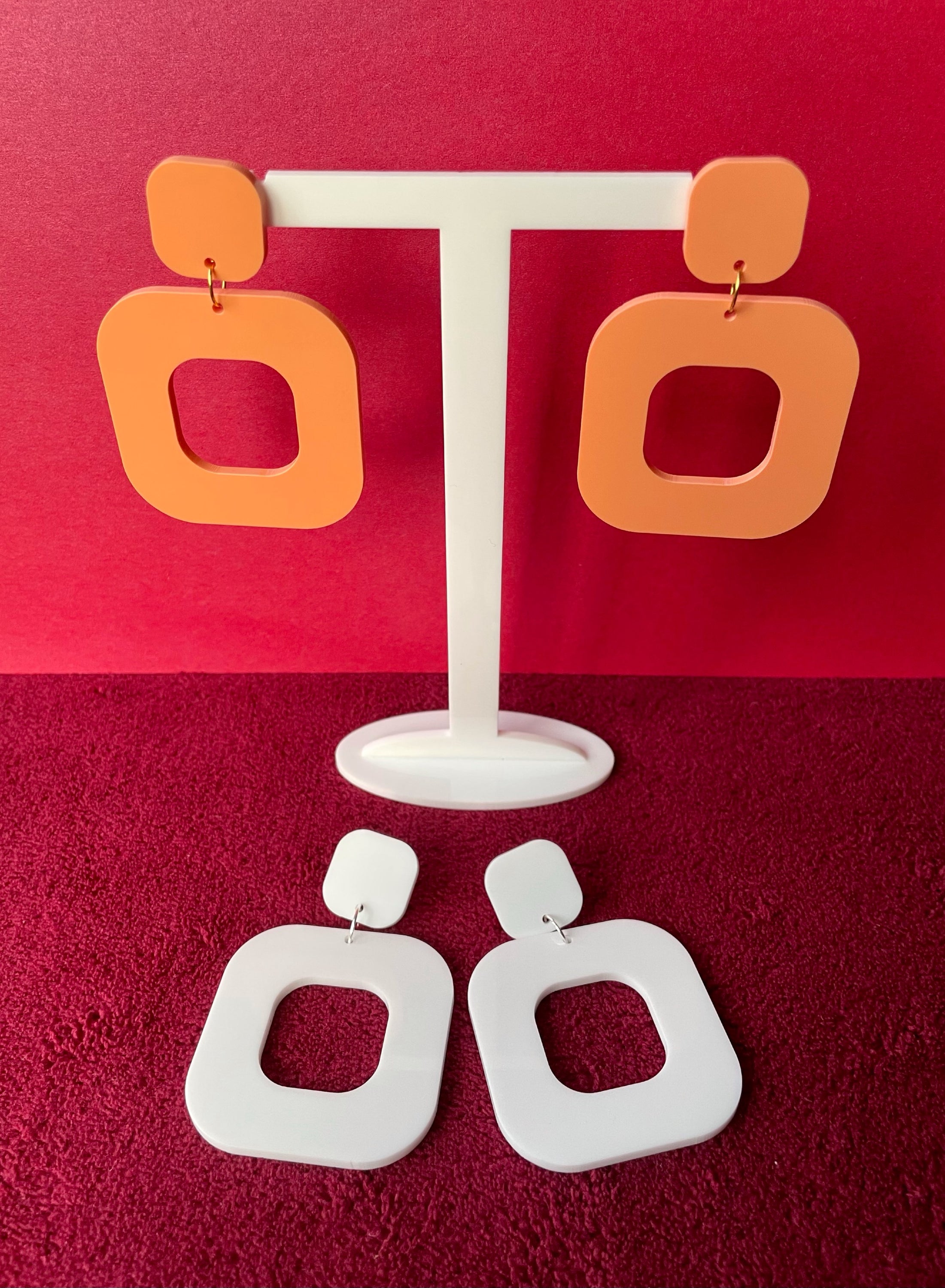 A pair of stylish rounded square earrings made from laser cut acrylic, showcasing vibrant colors and a modern design.