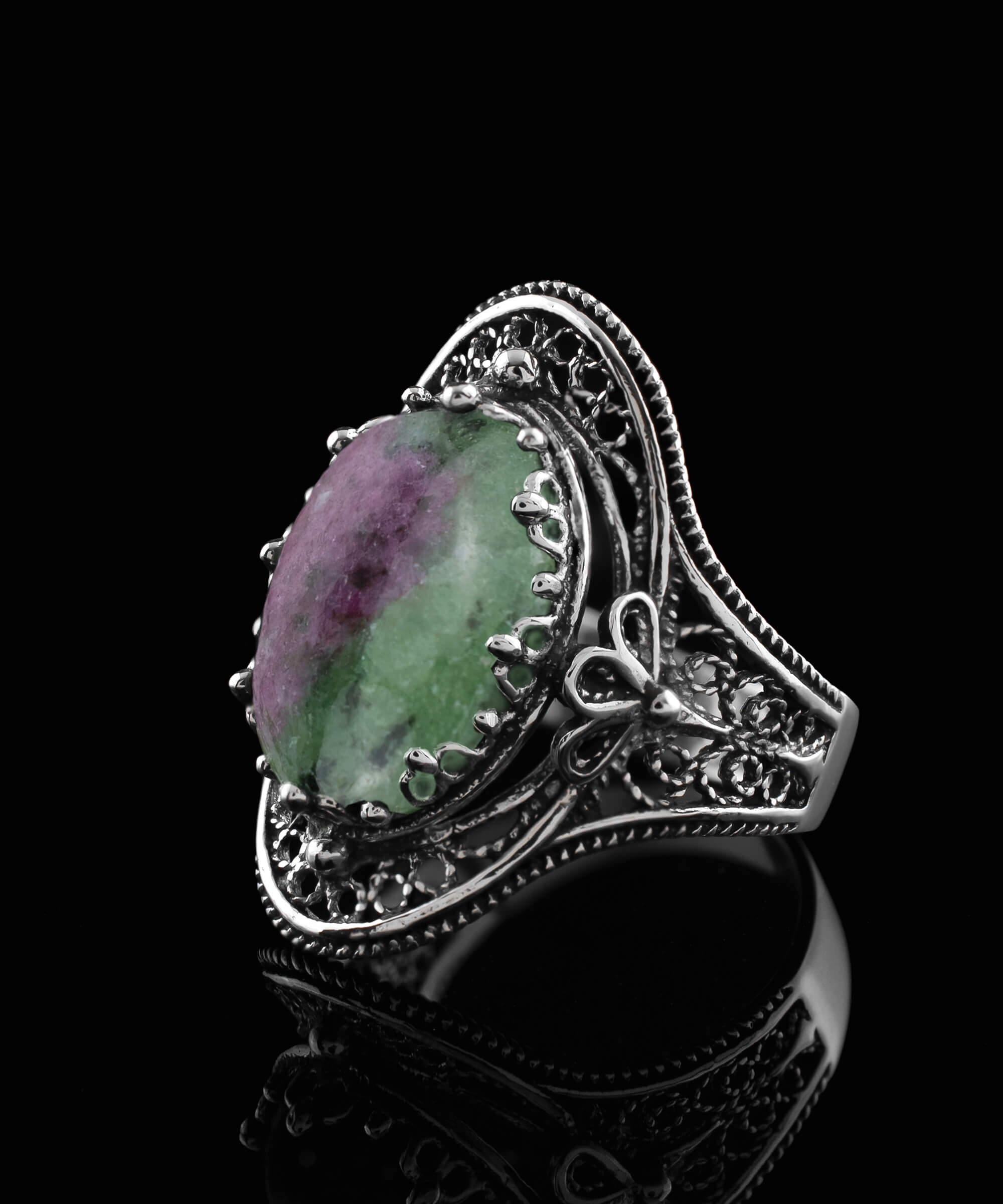 A stunning Ruby Zoisite gemstone filigree art ring made of sterling silver, showcasing intricate designs and a vibrant green-red stone.