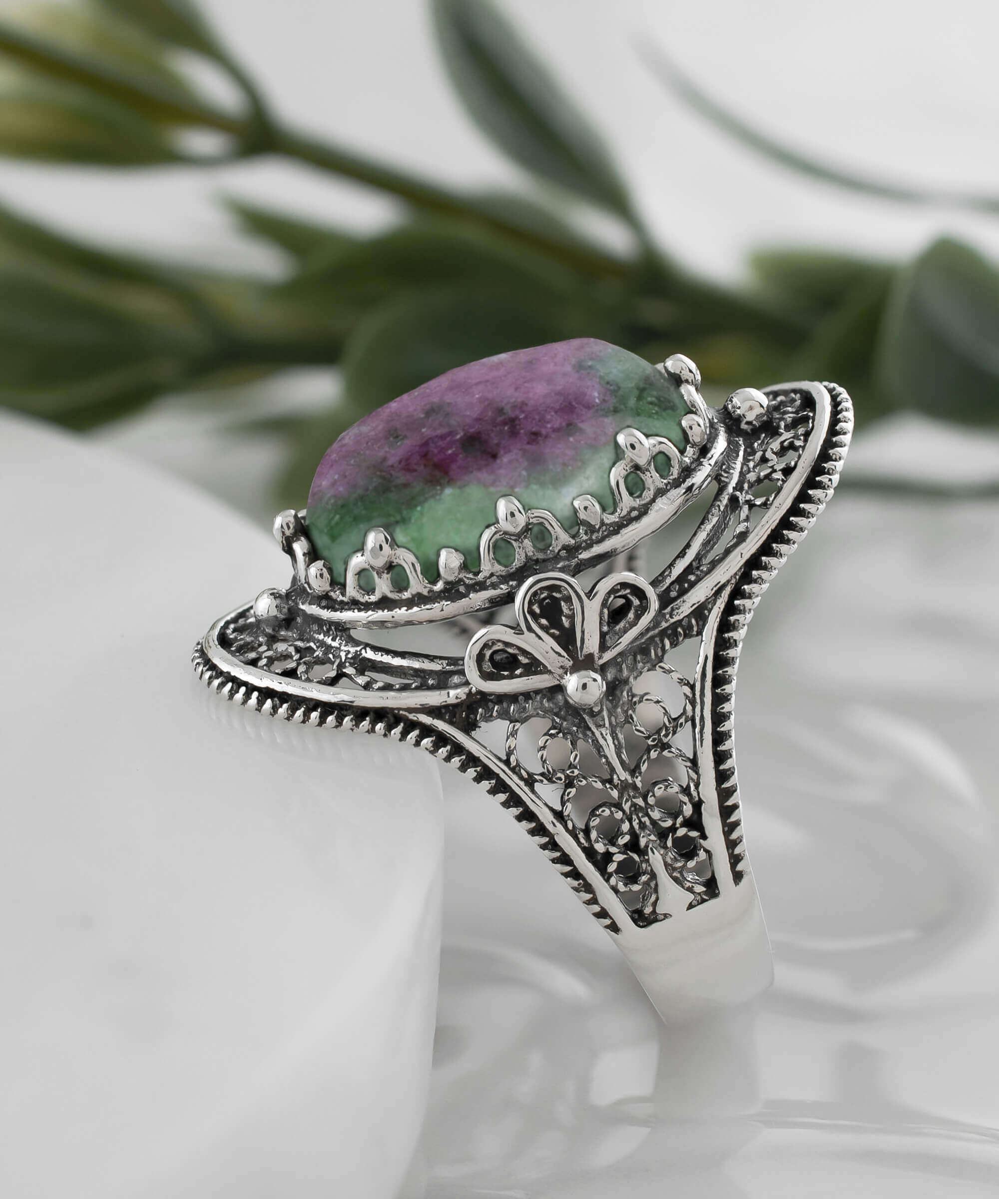A stunning Ruby Zoisite gemstone filigree art ring made of sterling silver, showcasing intricate designs and a vibrant green-red stone.