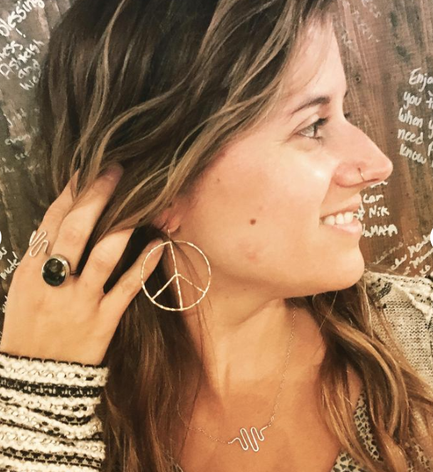 A pair of large rustic peace sign earrings made from hammered 16g wire, showcasing a unique handmade design with an organic texture.