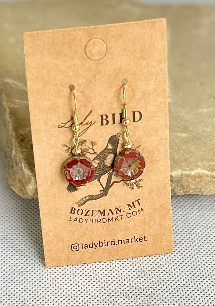 Rustic red etched glass hibiscus flower coin earrings, showcasing vibrant burgundy color and intricate wild rose design.