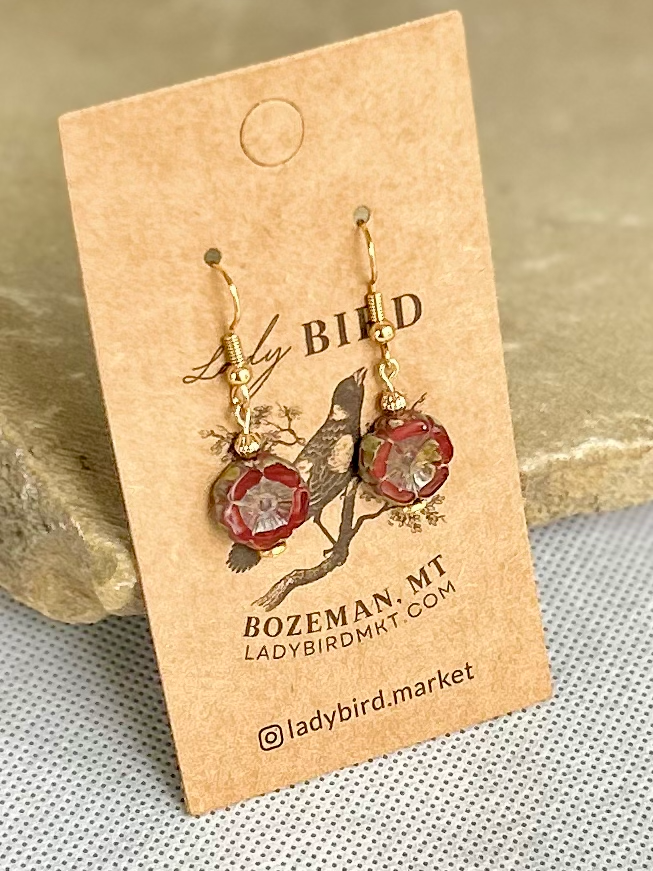 Rustic red etched glass hibiscus flower coin earrings, showcasing vibrant burgundy color and intricate wild rose design.