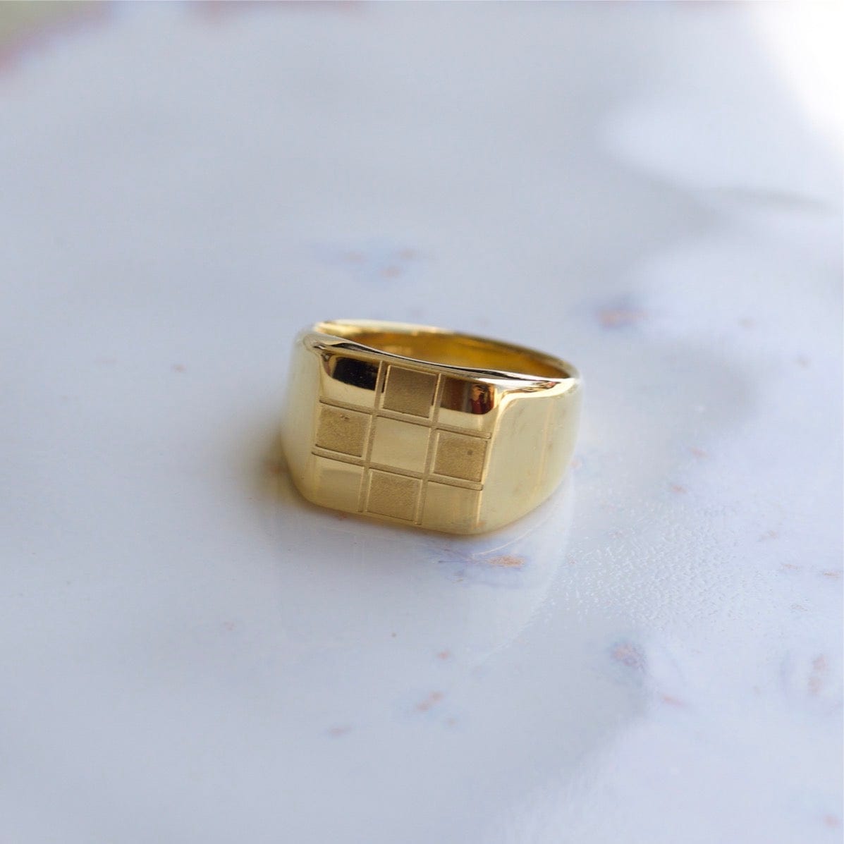 Sacra Geometric Gold Check-board Block Ring showcasing its elegant design and 18Kt yellow gold coating.